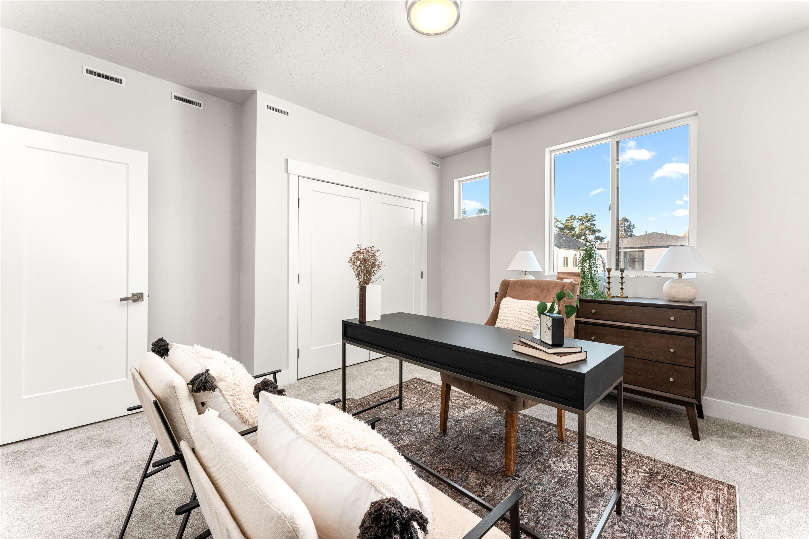 Home office with light carpet and baseboards