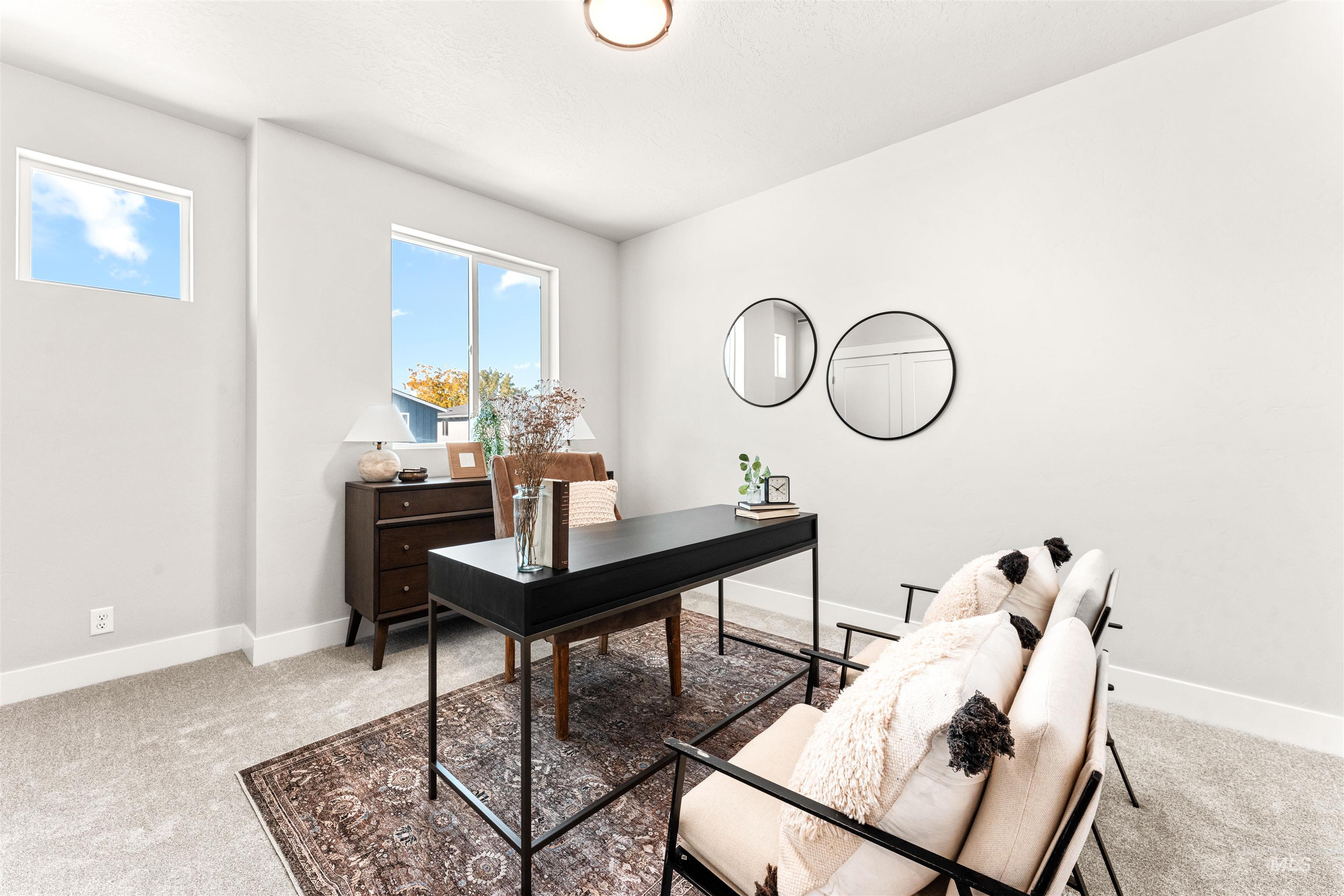Home office featuring light carpet and baseboards
