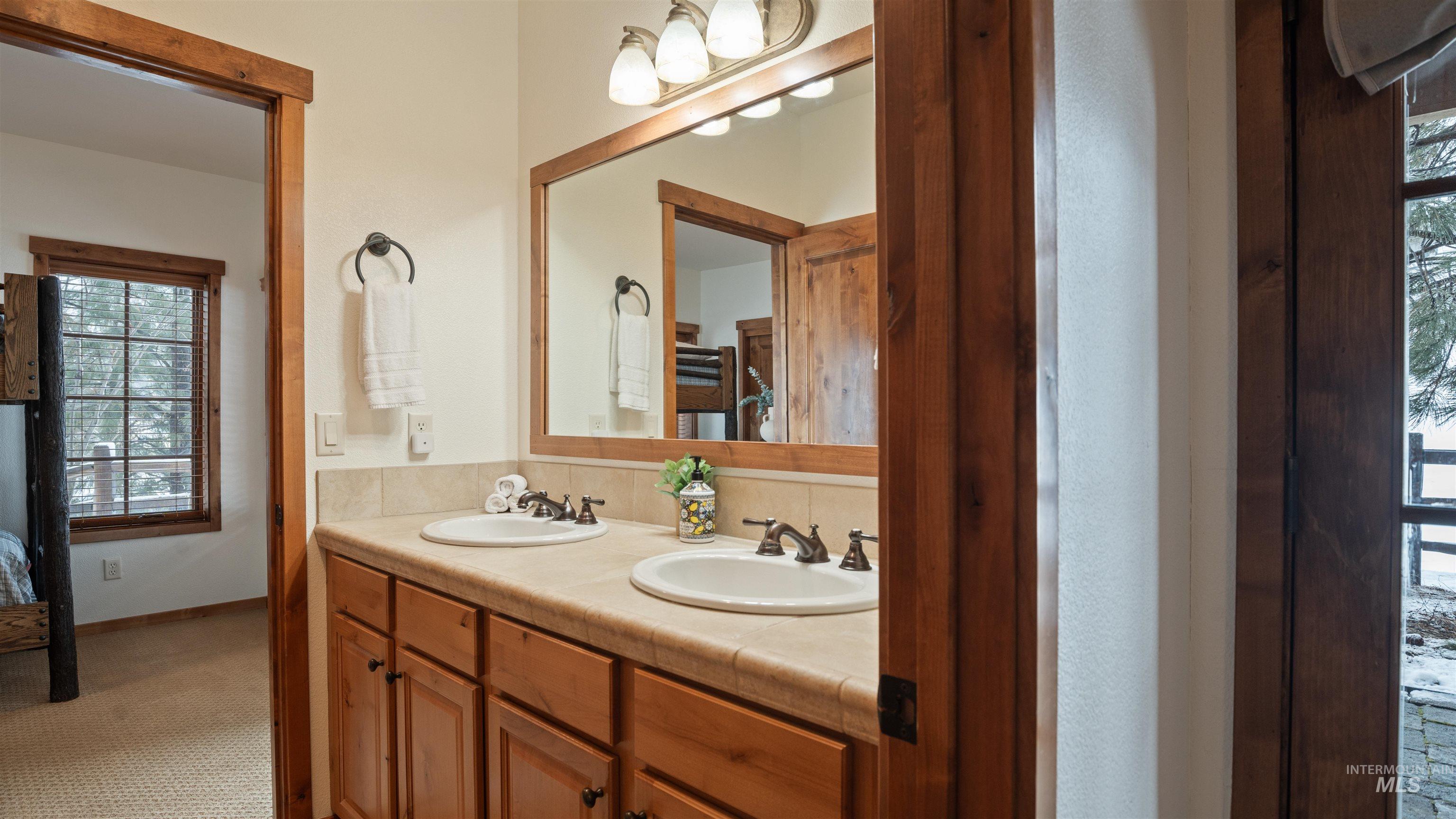 Full bathroom with double vanity and ensuite bathroom