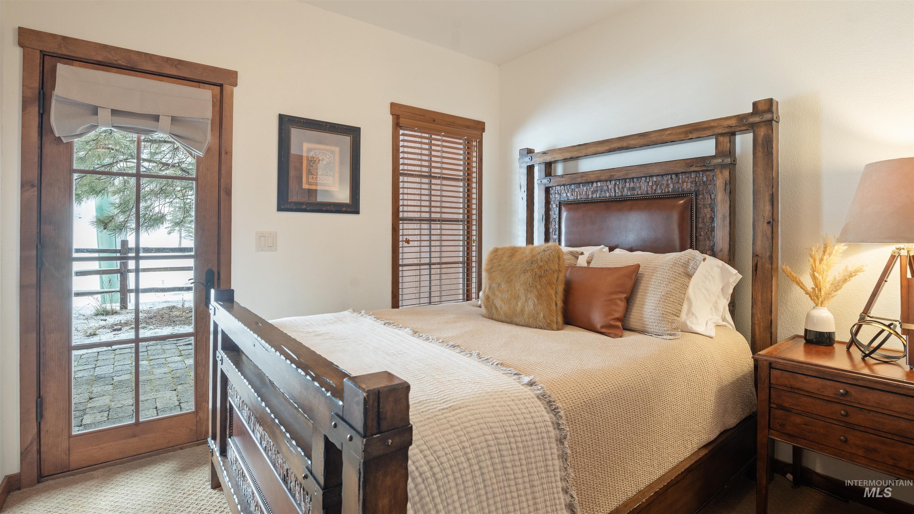 Bedroom with multiple windows and access to exterior