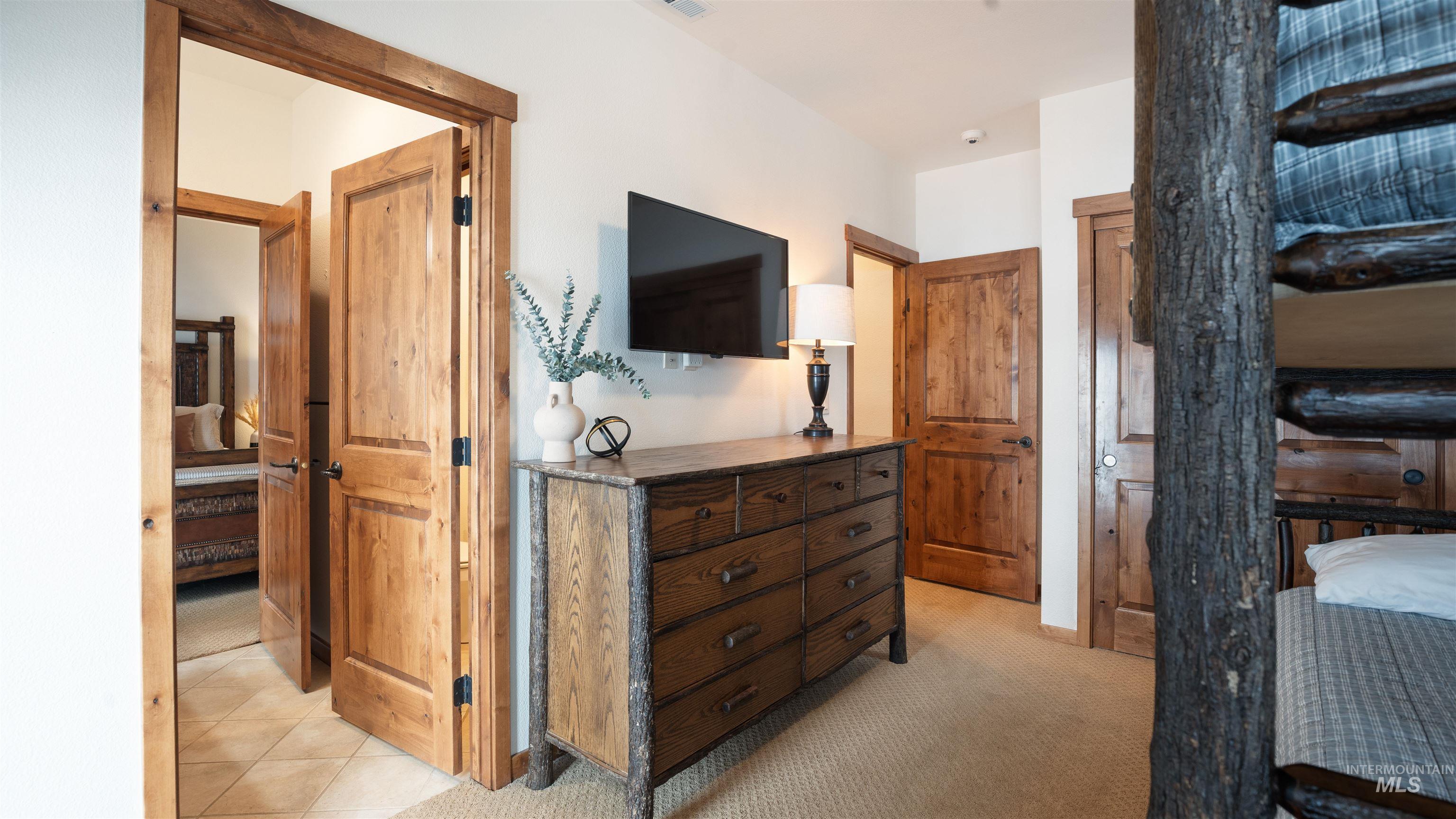 Bedroom featuring light carpet