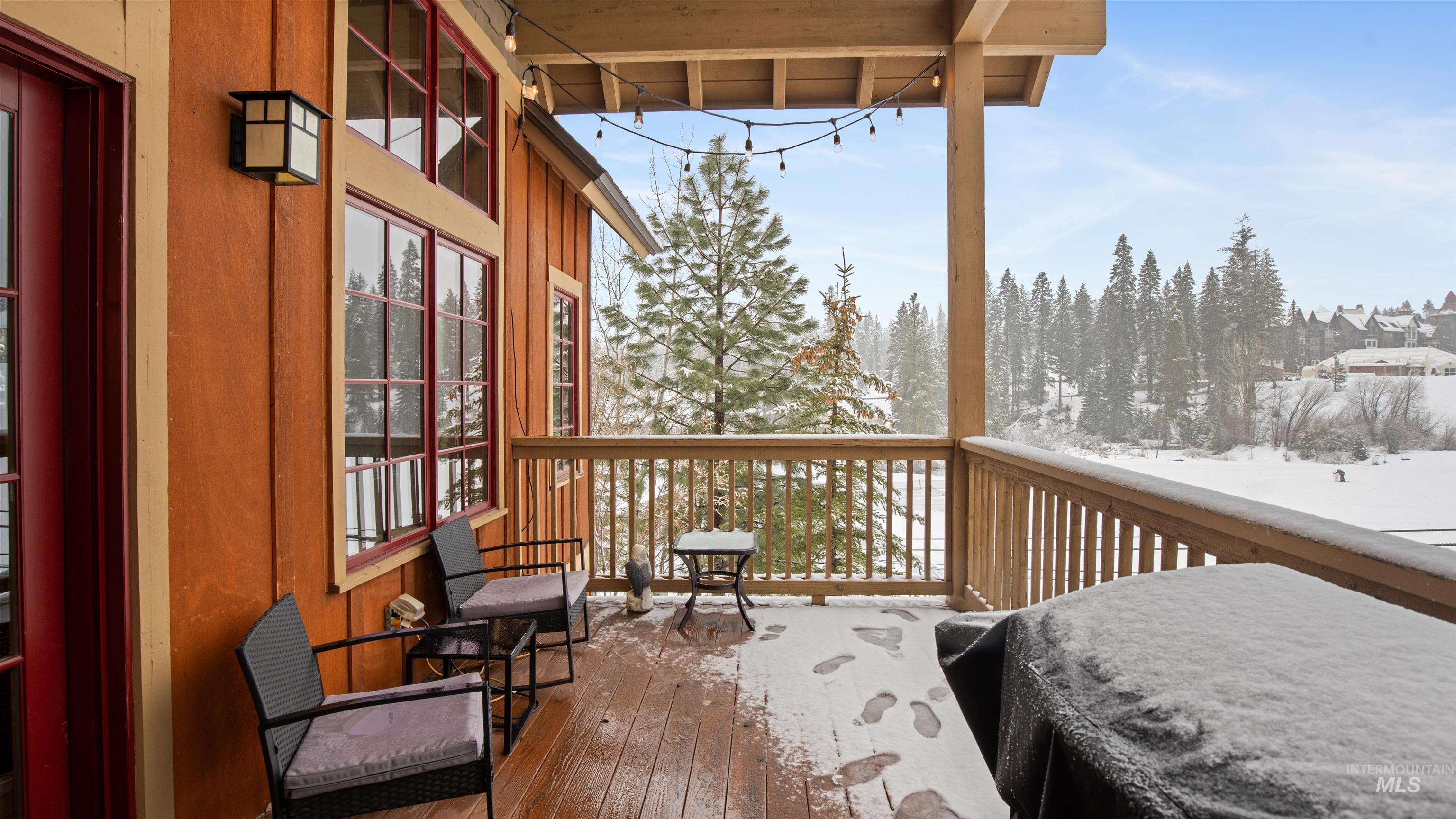 Snow covered deck with a balcony