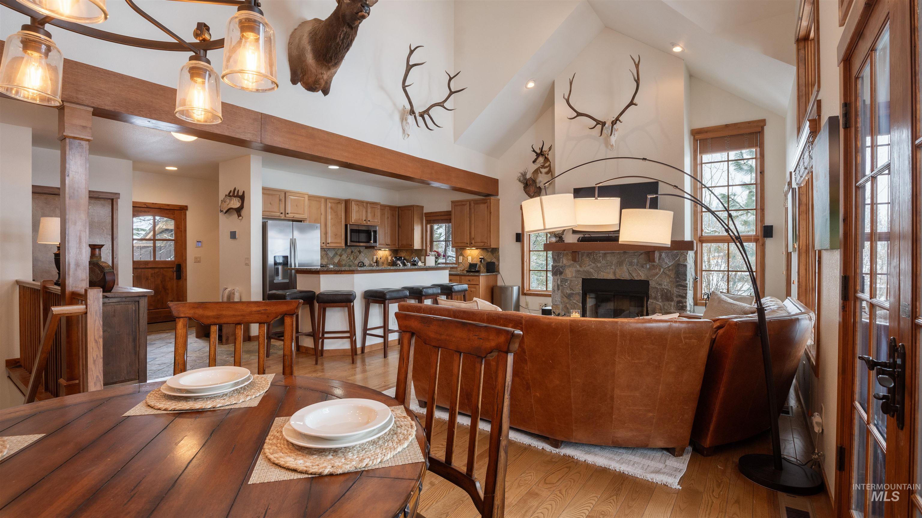 Living area featuring recessed lighting, light wood finished floors, lofted ceiling, and a fireplace