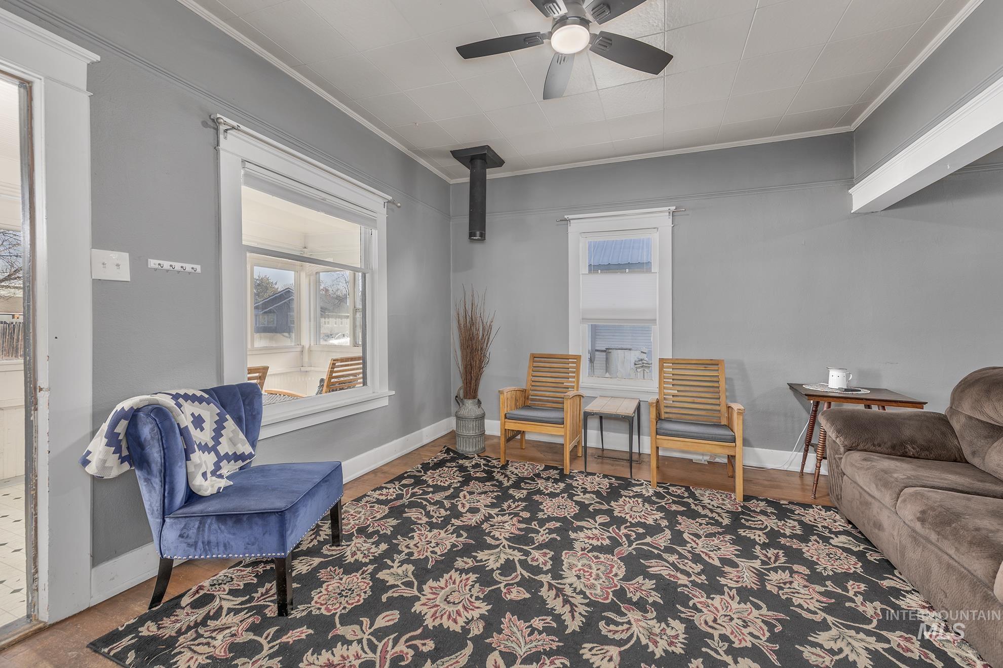 Sitting room featuring a ceiling fan and ornamental molding
