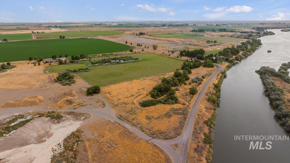 Aerial view of property and surrounding area with rural landscape and a nearby body of water