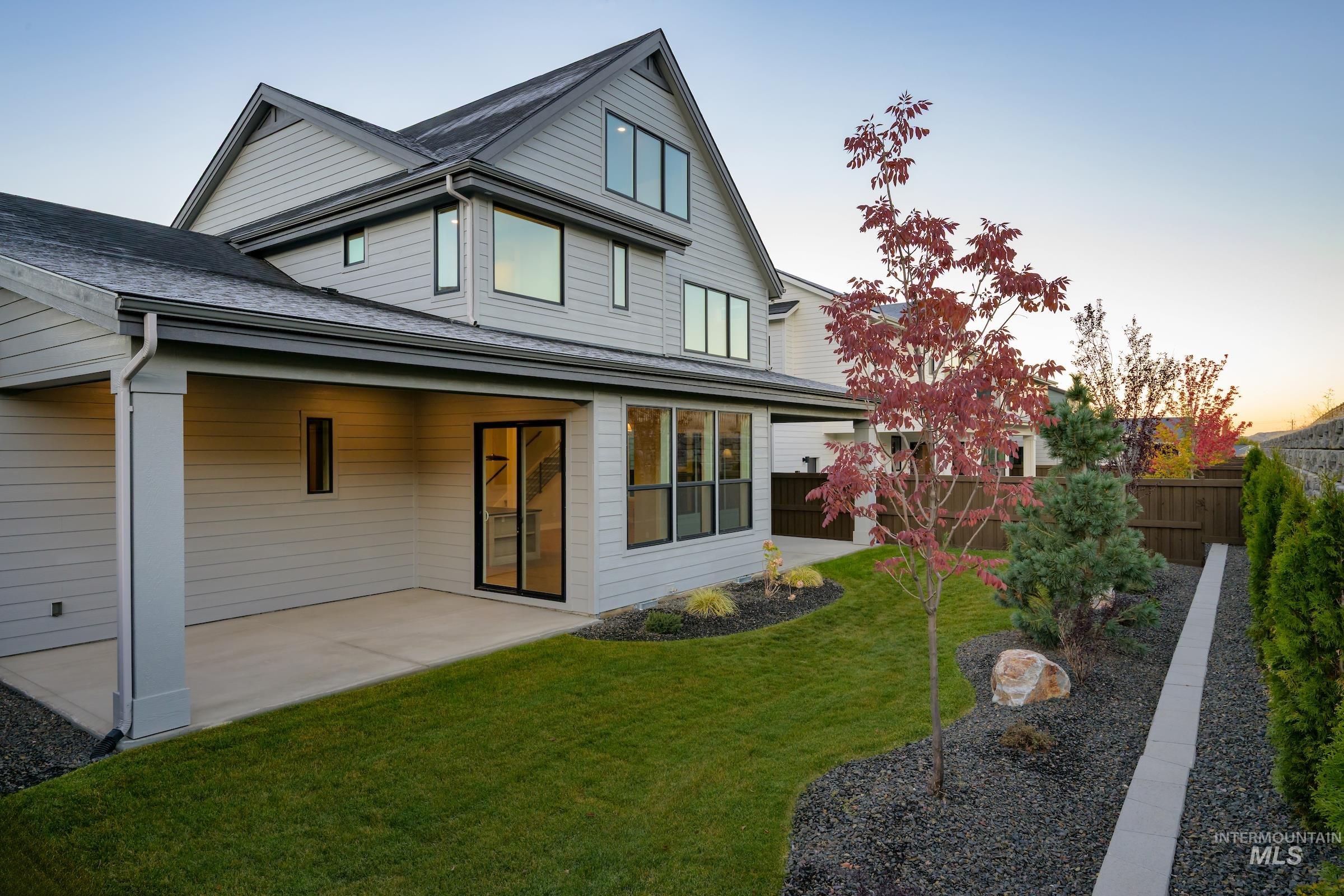 Rear view of property with a patio and roof with shingles
