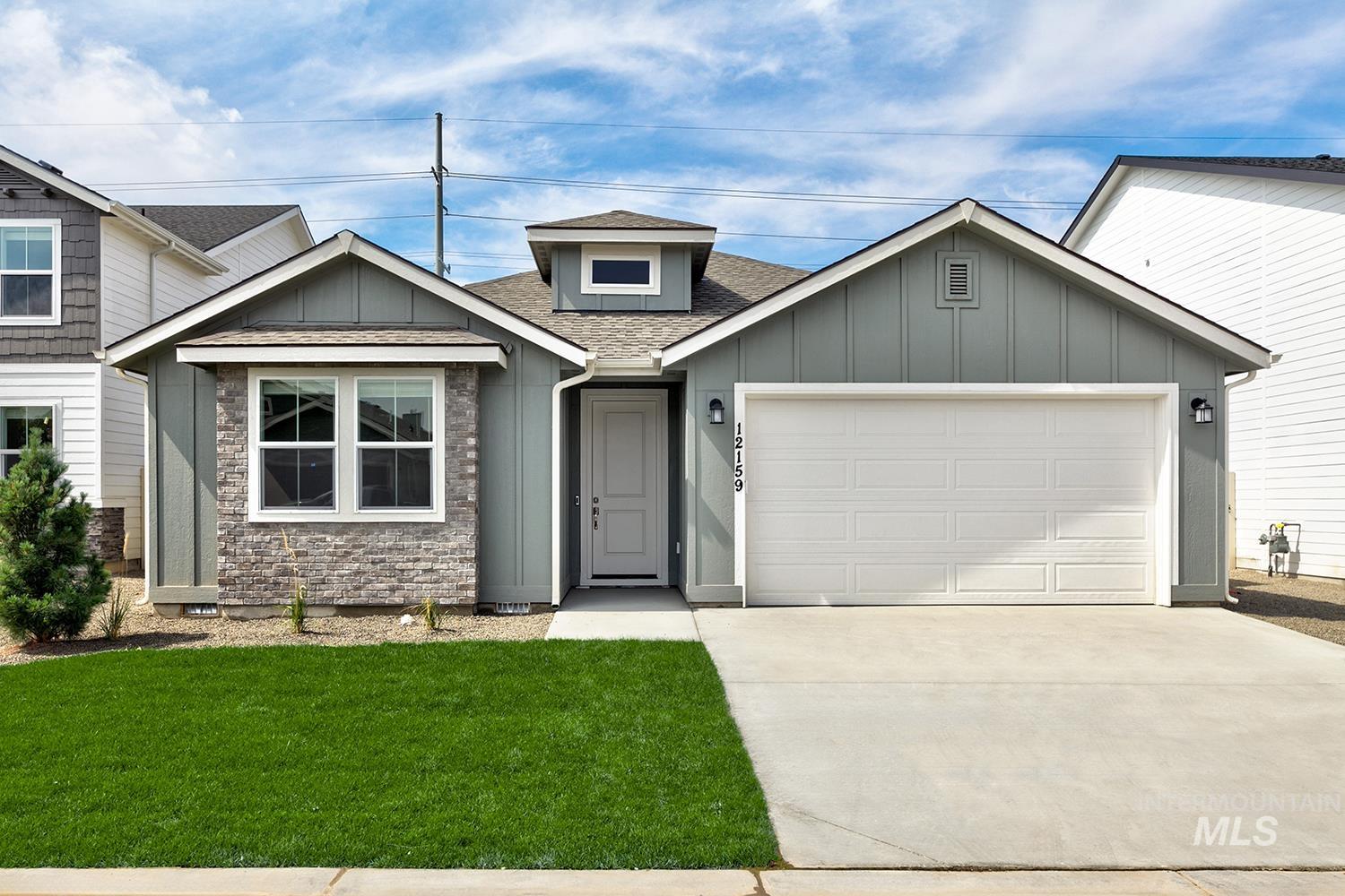 Craftsman-style house featuring a shingled roof, board and batten siding, concrete driveway, and a garage