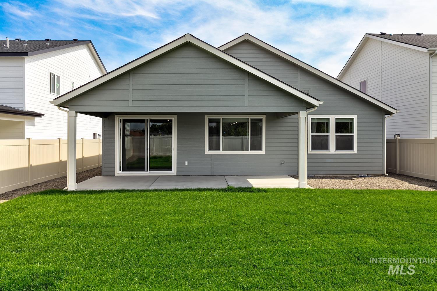 Back of property with a fenced backyard and a patio