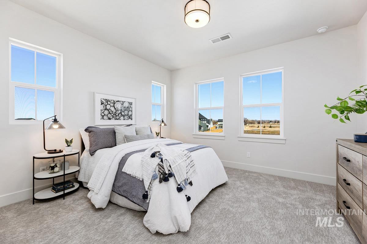 Bedroom with light colored carpet