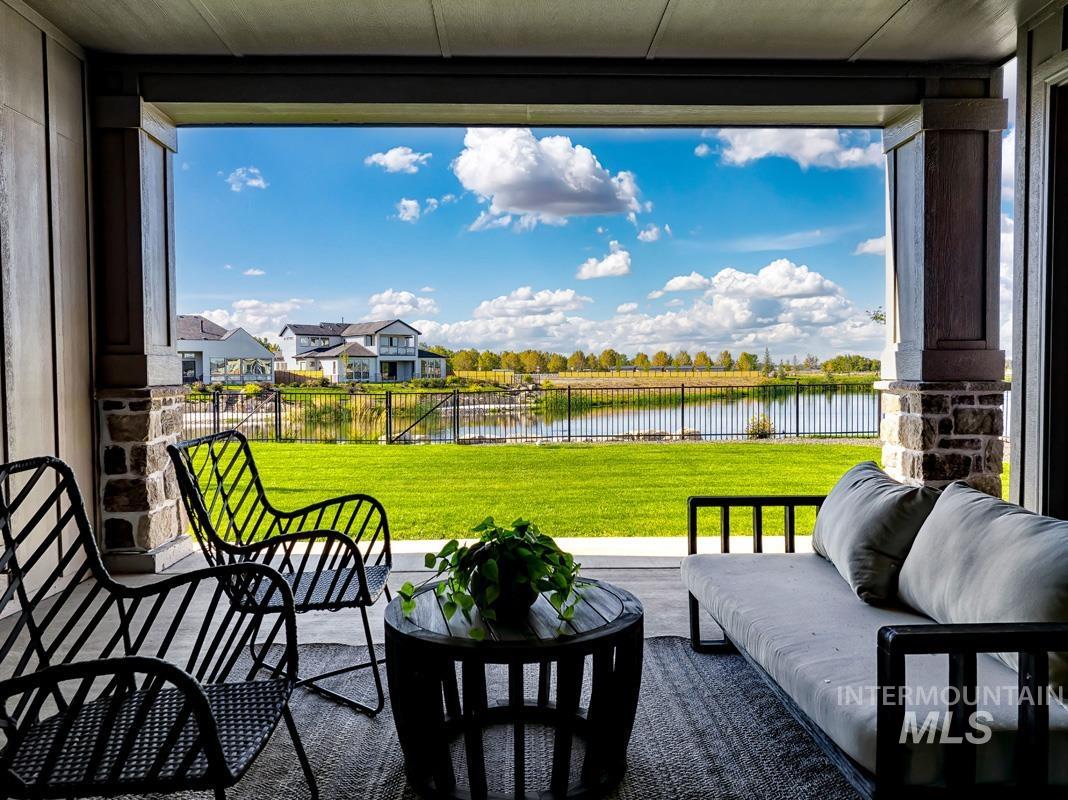Fenced backyard with a patio and a water view