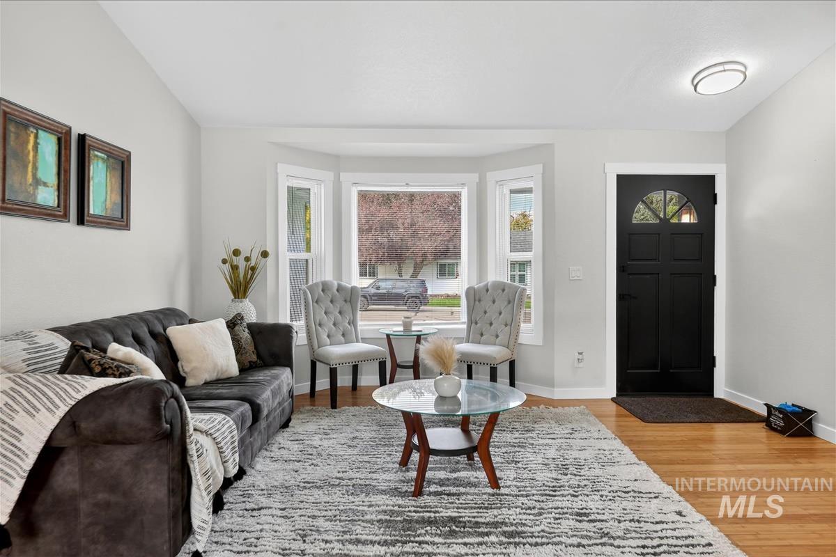 Living area featuring light wood-style flooring and baseboards
