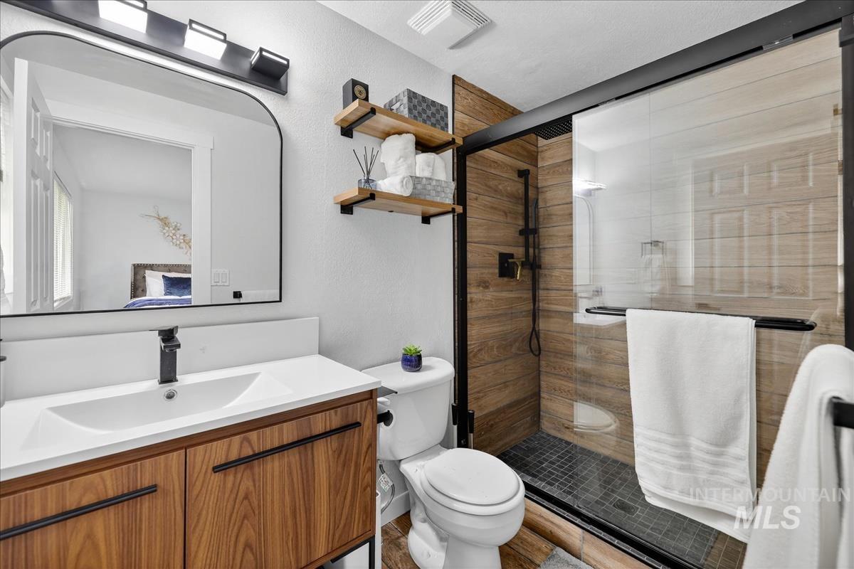 Bathroom with vanity and a shower stall