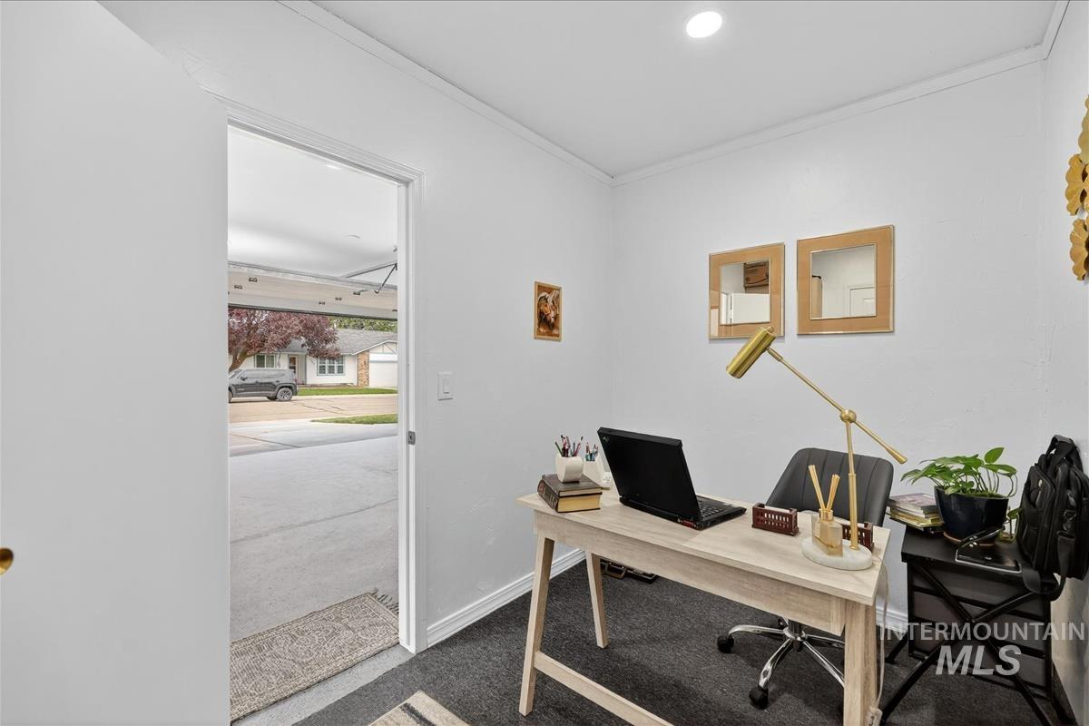 Office space with crown molding and carpet floors
