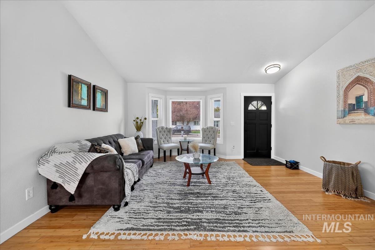 Living room with light wood-style flooring and baseboards