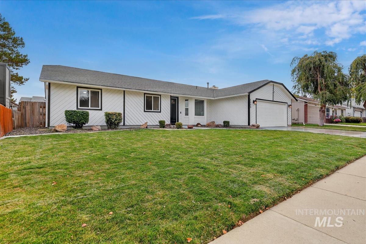 Ranch-style home with a garage and concrete driveway