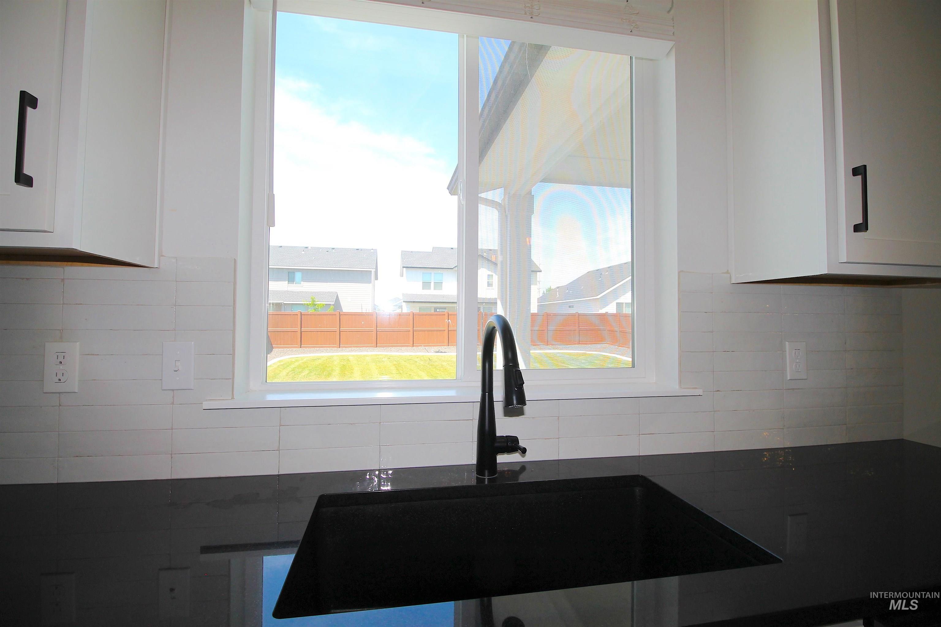 Kitchen sink featuring a matte black fixture, undermount sink, and dark countertop