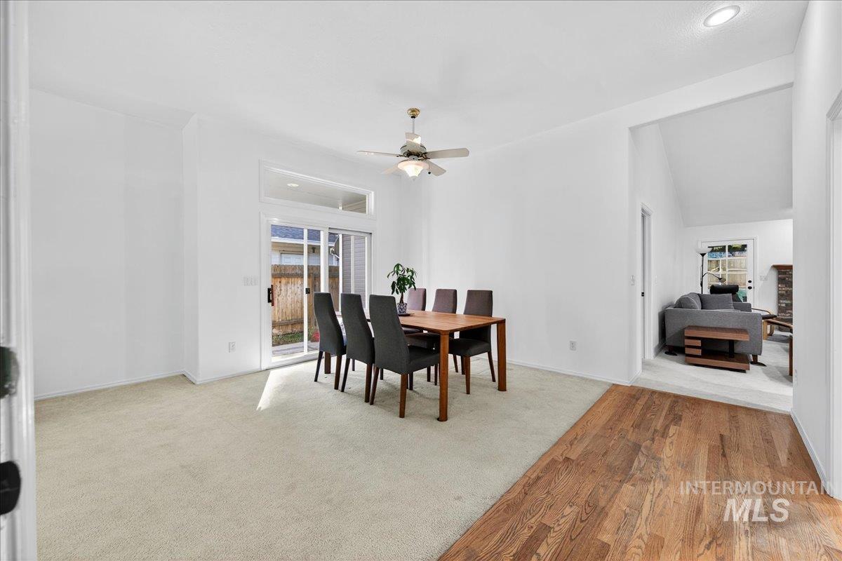 Dining area featuring light carpet, light wood finished floors, and a ceiling fan