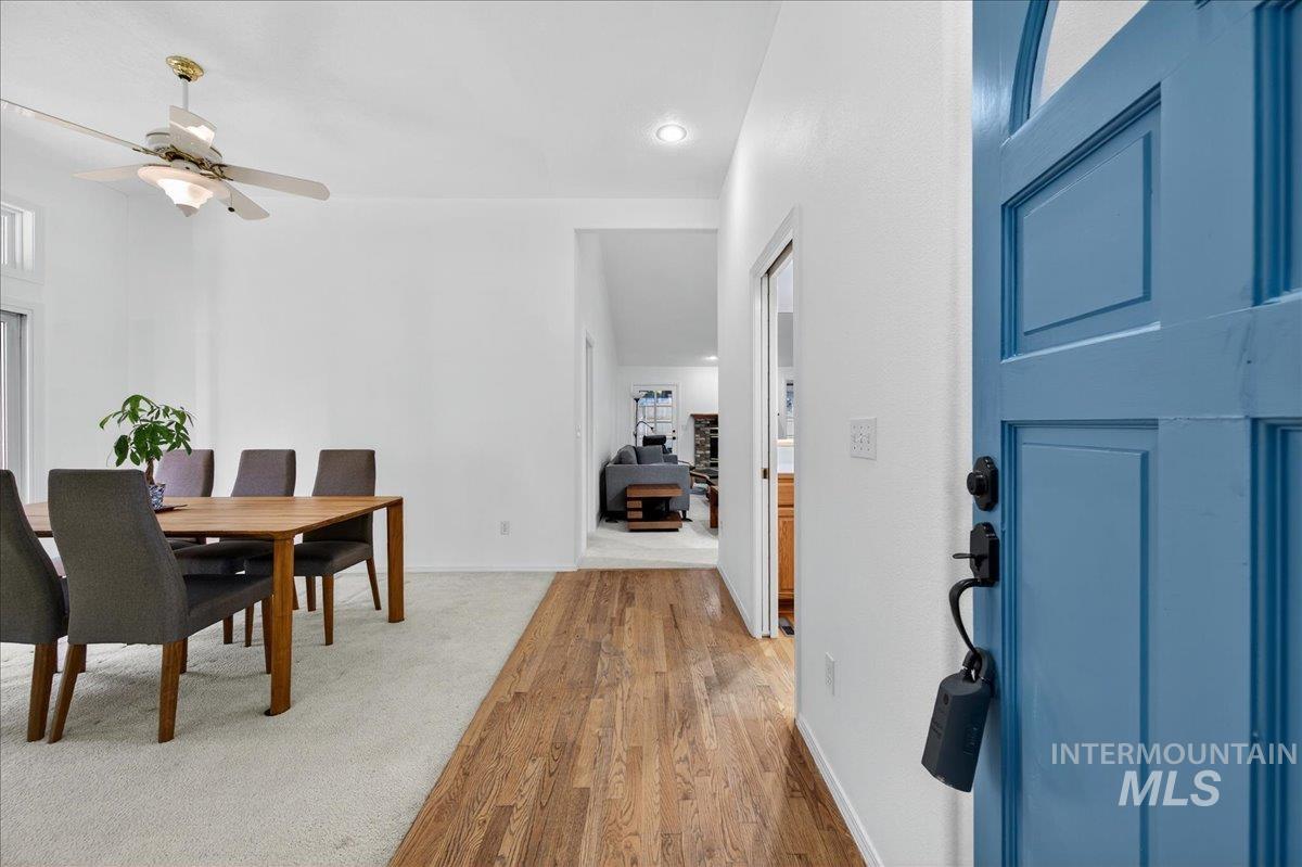 Dining room with light wood-style floors and a ceiling fan