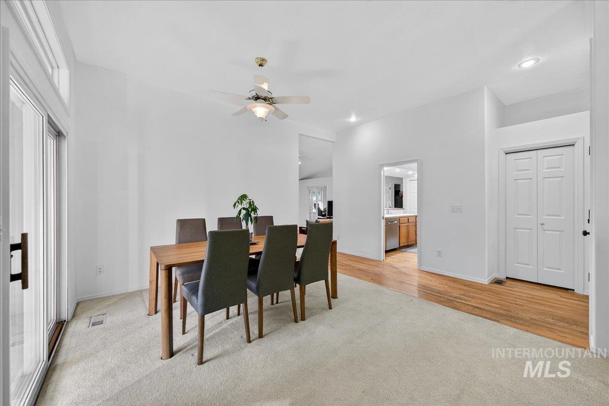 Dining room featuring light colored carpet, ceiling fan, light wood finished floors, and recessed lighting