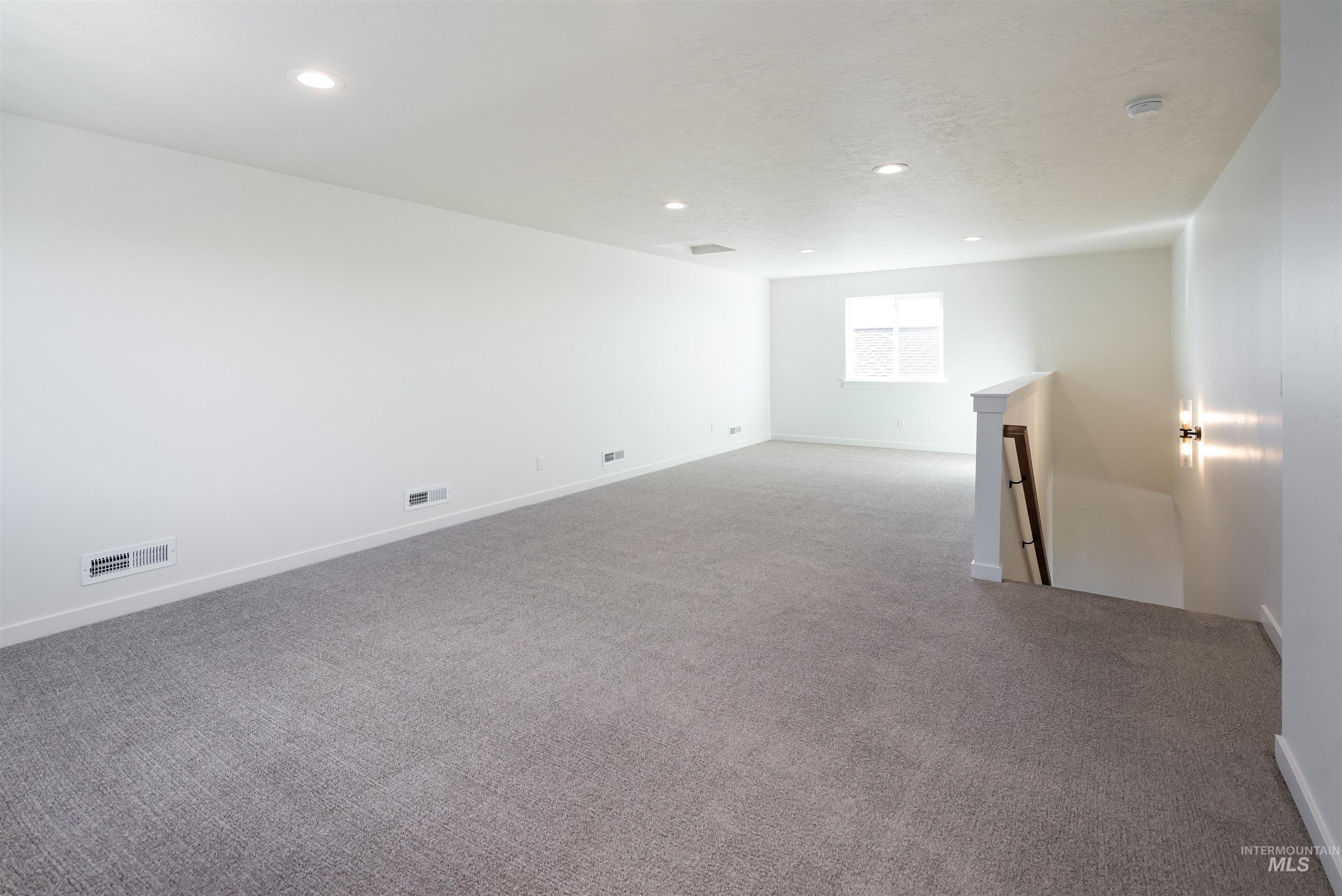 Spare room featuring carpet and recessed lighting