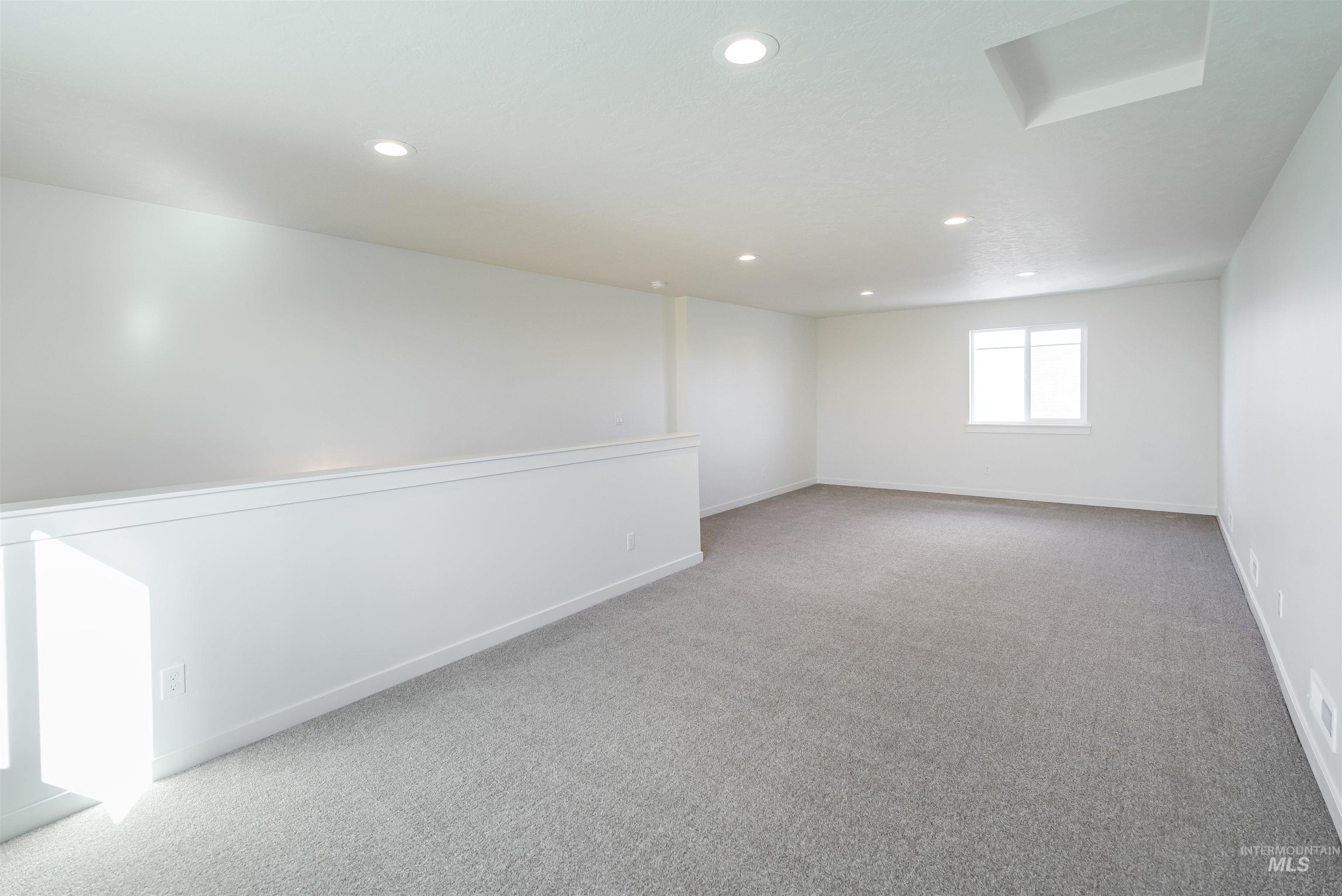 Spare room with light colored carpet and recessed lighting