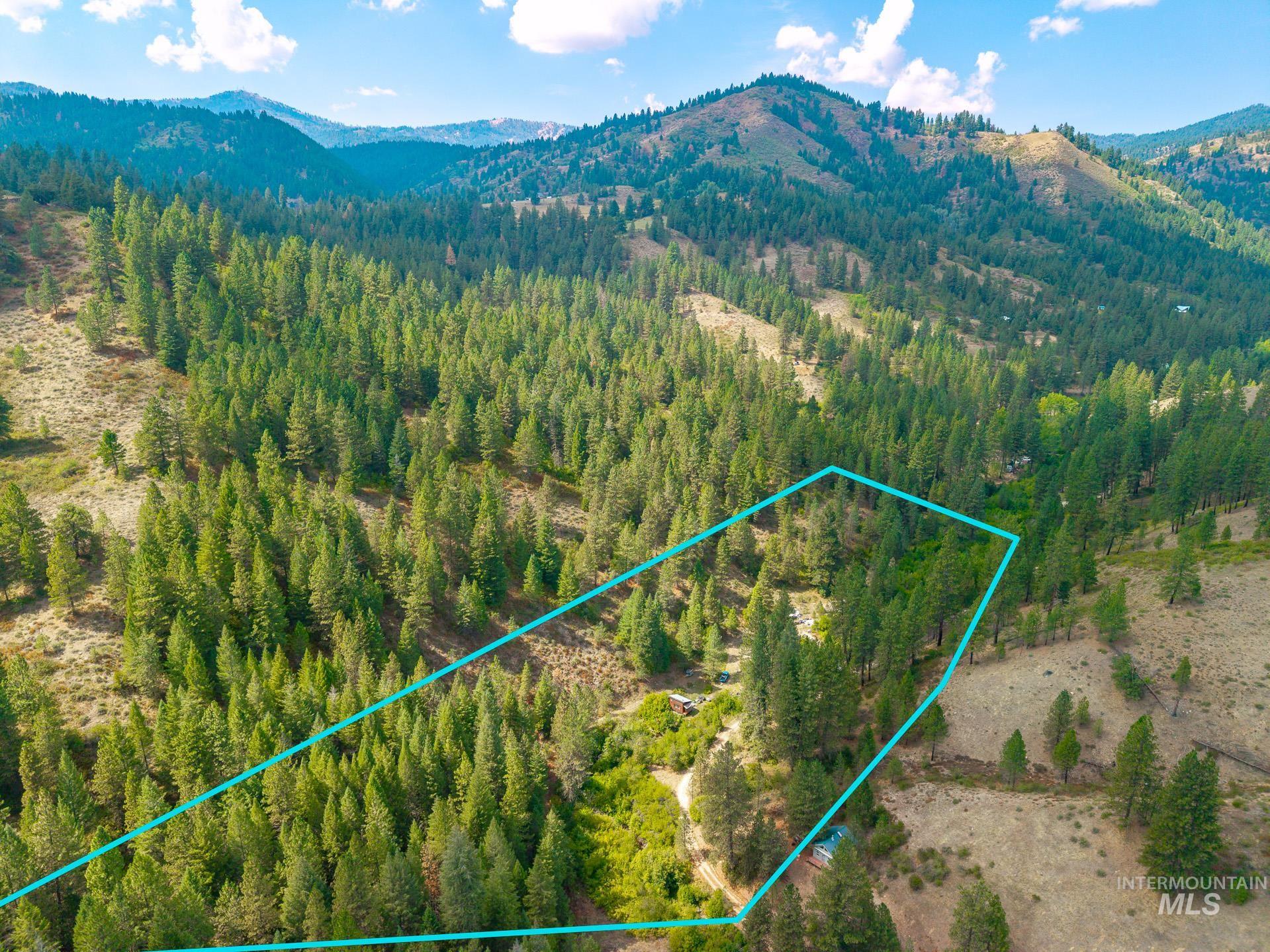 Aerial overview of property's location featuring mountains and property parcel outlined