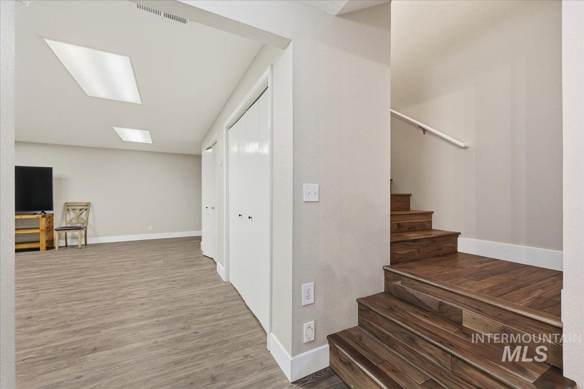Staircase featuring wood finished floors and baseboards