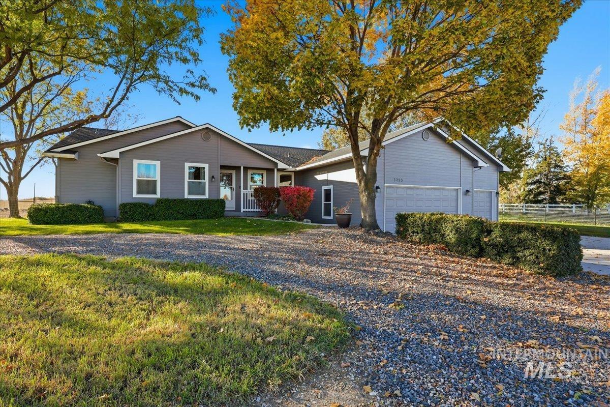 Single story home featuring a garage and driveway