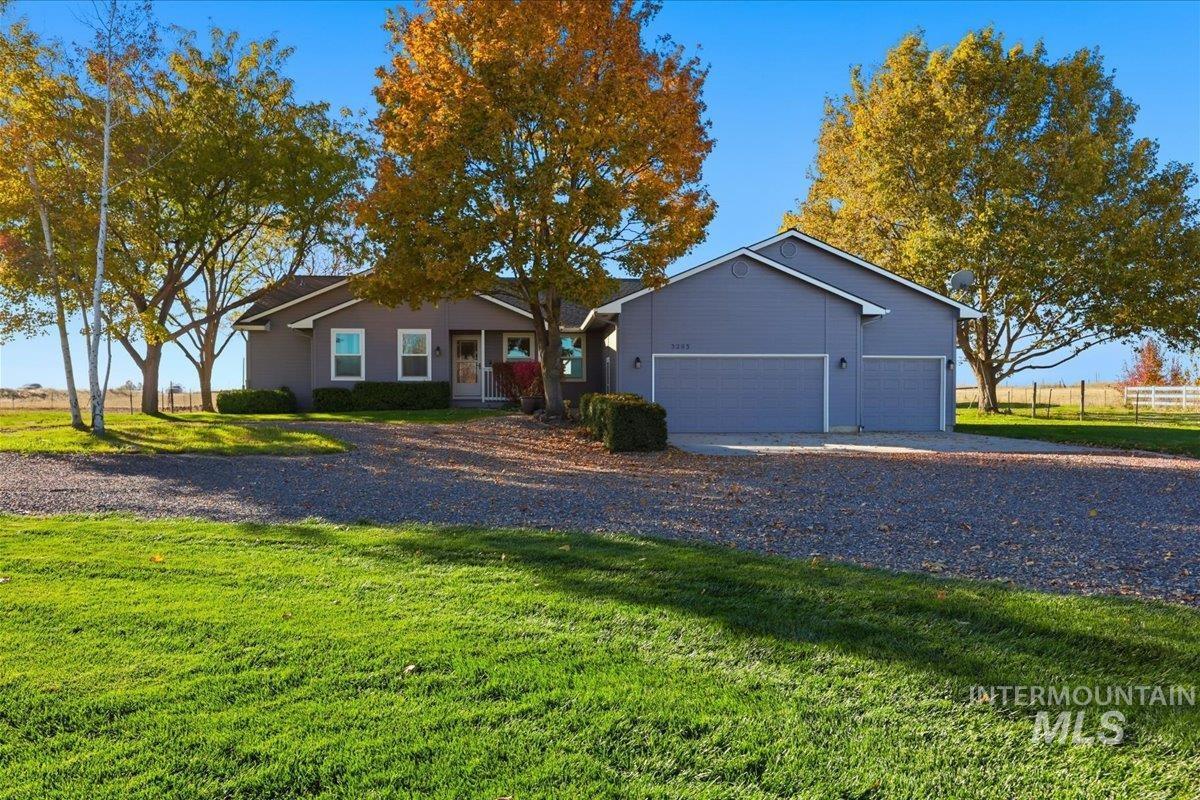 Ranch-style house featuring an attached garage and driveway