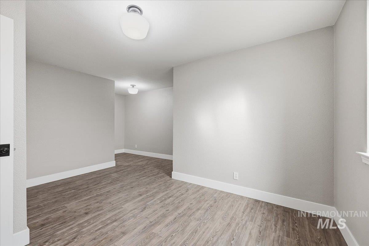 Empty room with light wood finished floors and baseboards