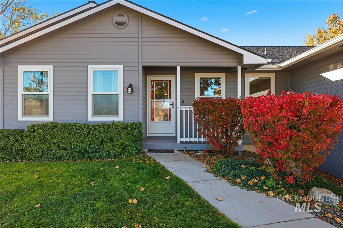 View of front of home with a front lawn and a porch