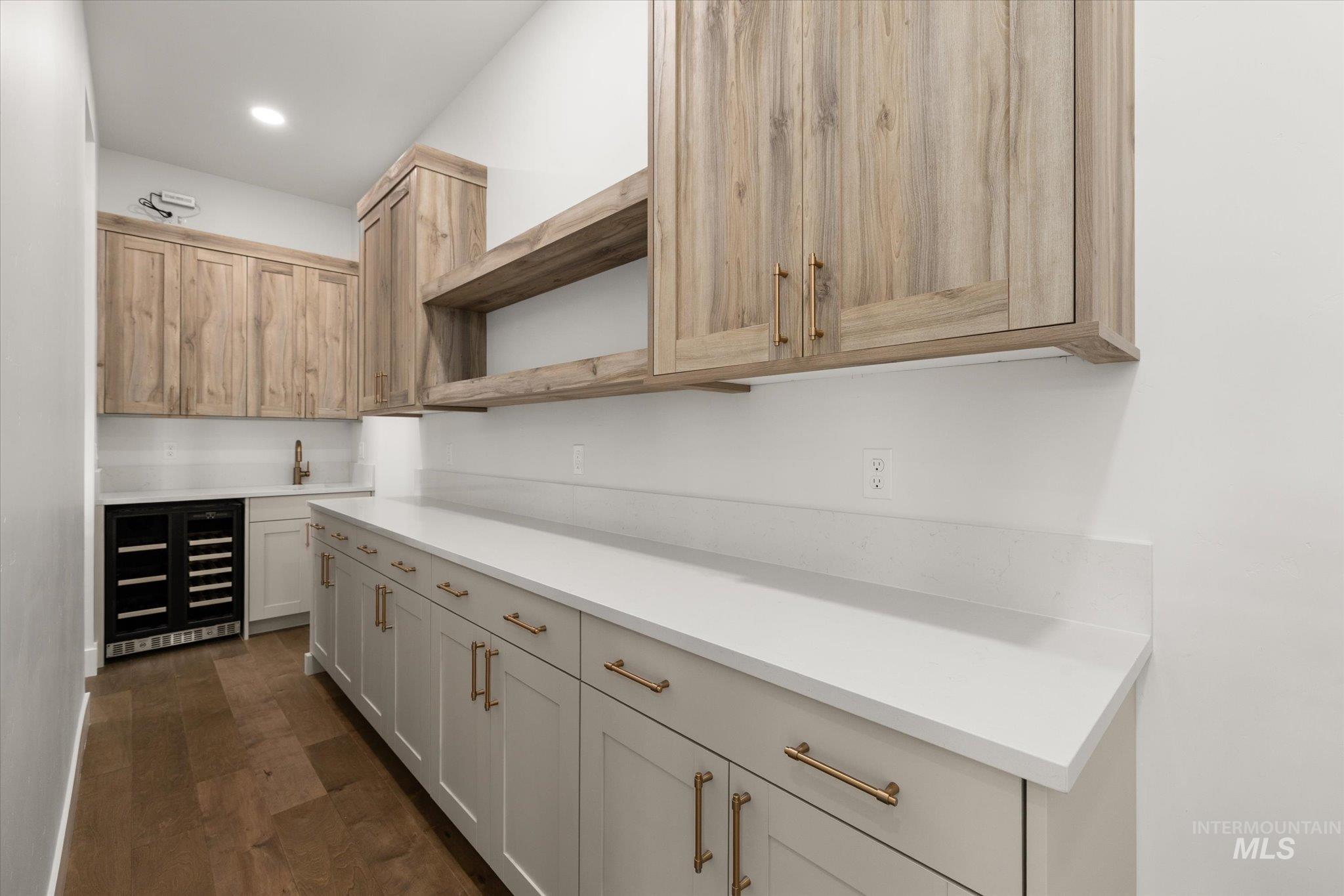 Walkthrough Pantry with open shelves, wine cooler, dark wood-style floors, and recessed lighting