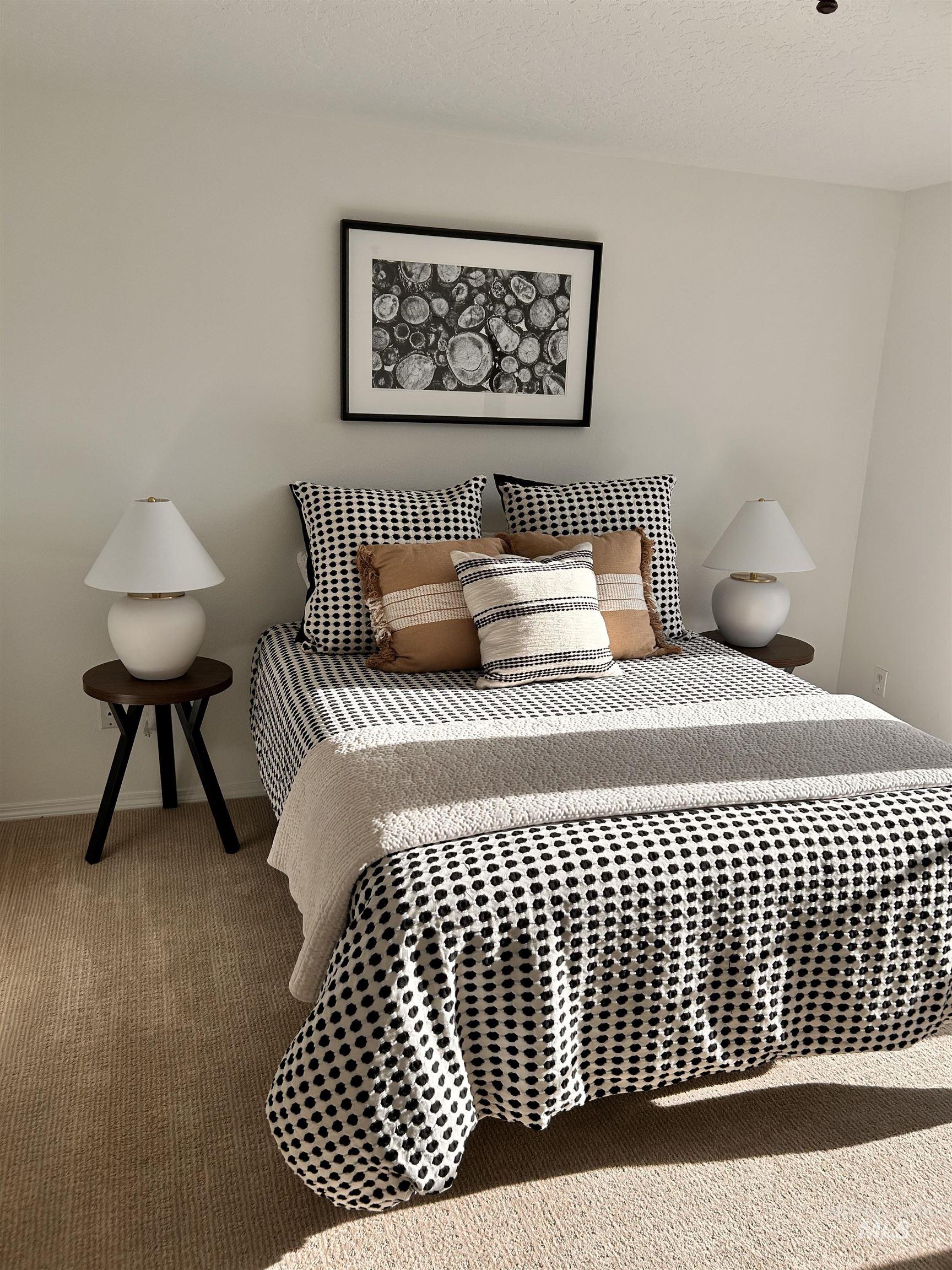 Carpeted bedroom with baseboards and a textured ceiling