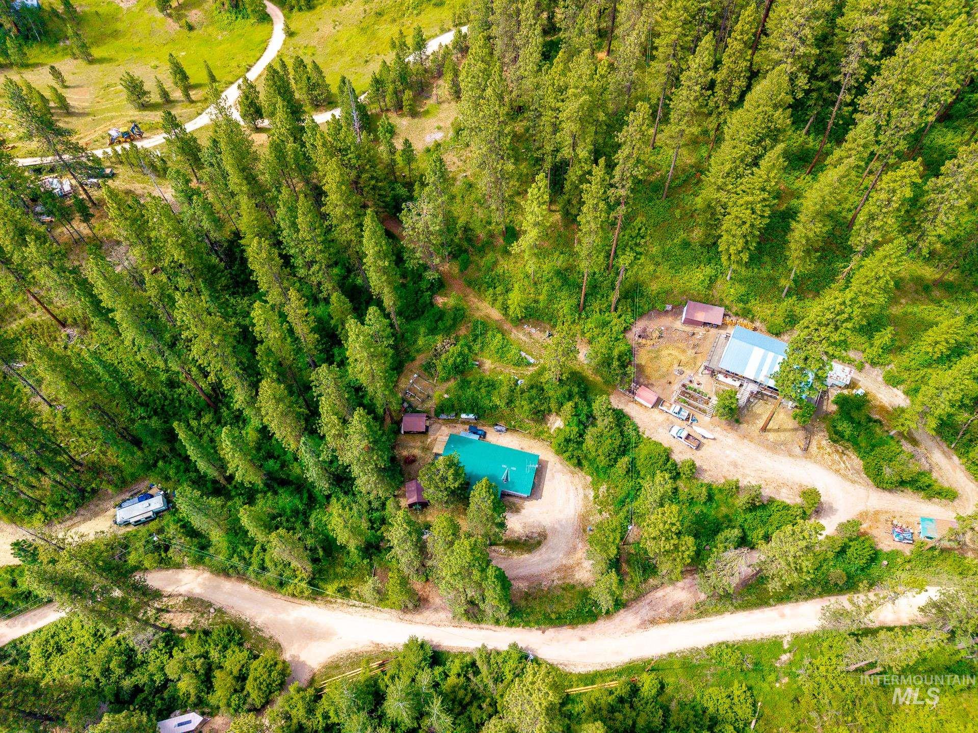 Expansive rural property featuring multiple structures and abundant natural forestry