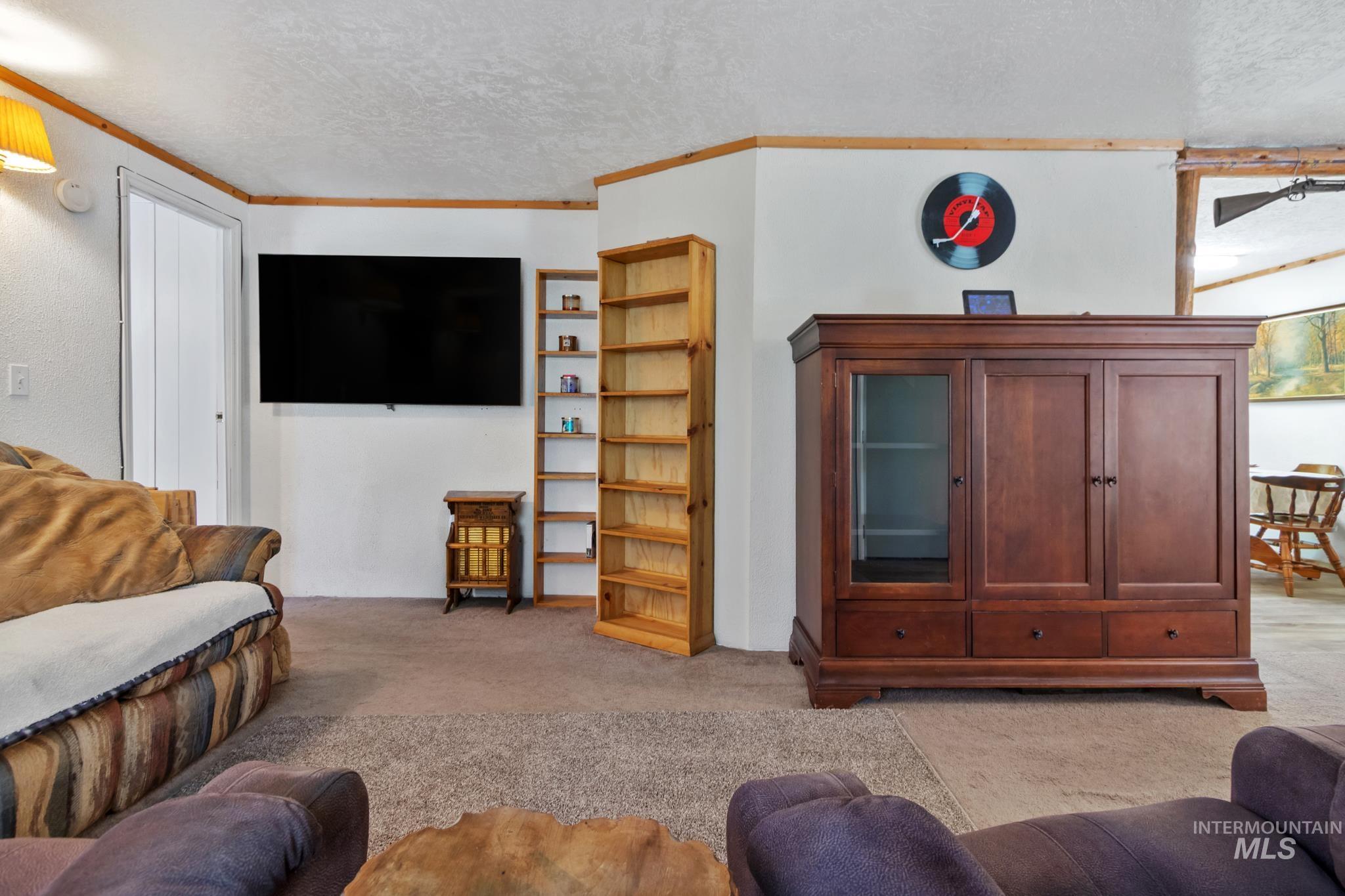 Living area featuring carpeted flooring and white walls
