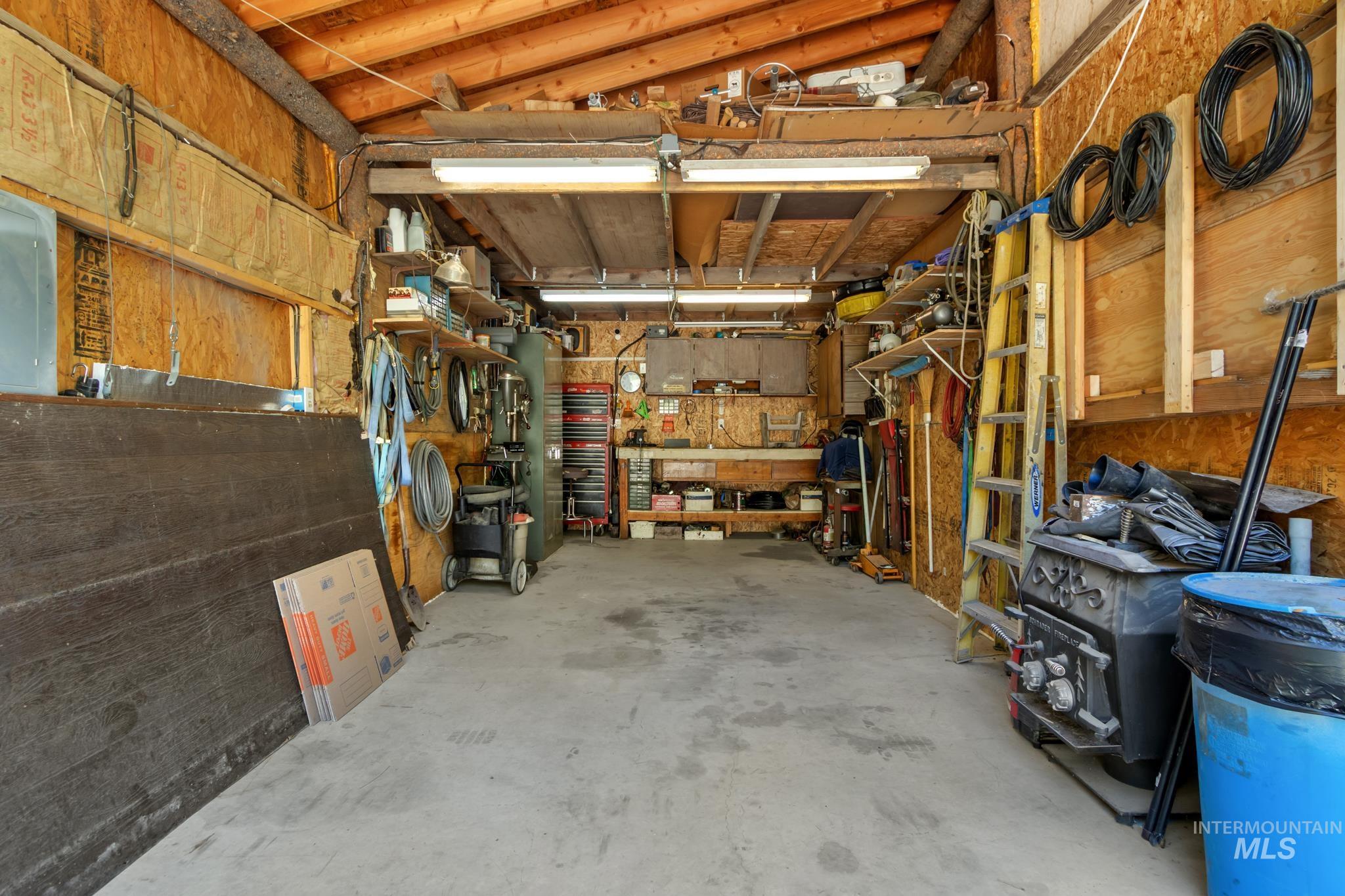 Concrete flooring with exposed wood framing and plywood walls