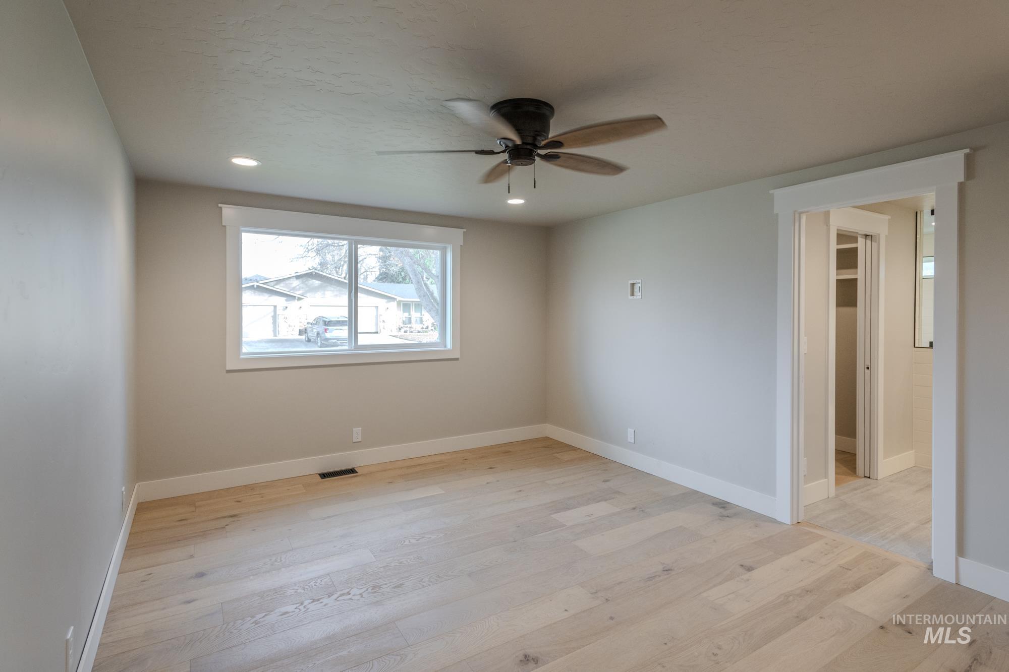 Light wood flooring, recessed lighting, and ceiling fan, walk in closet, and huge master bath with wet-room.