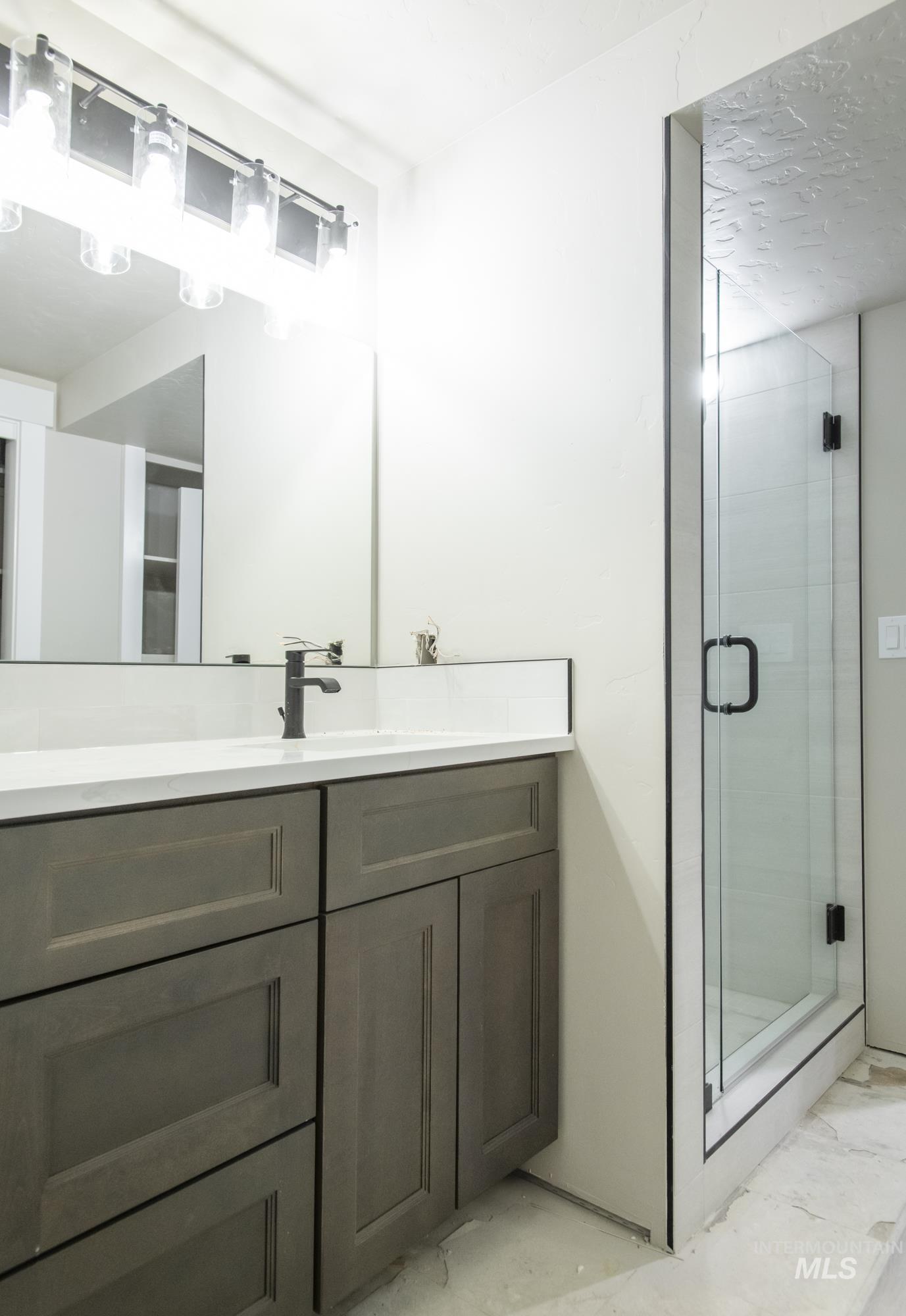 Full bath with vanity, tons of storage, and a shower stall