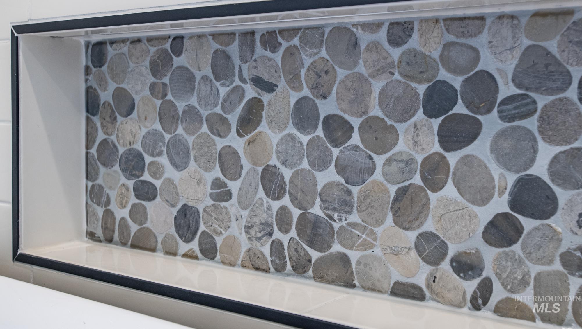 Pebble Tile finishes and recessed lighting in wet-room