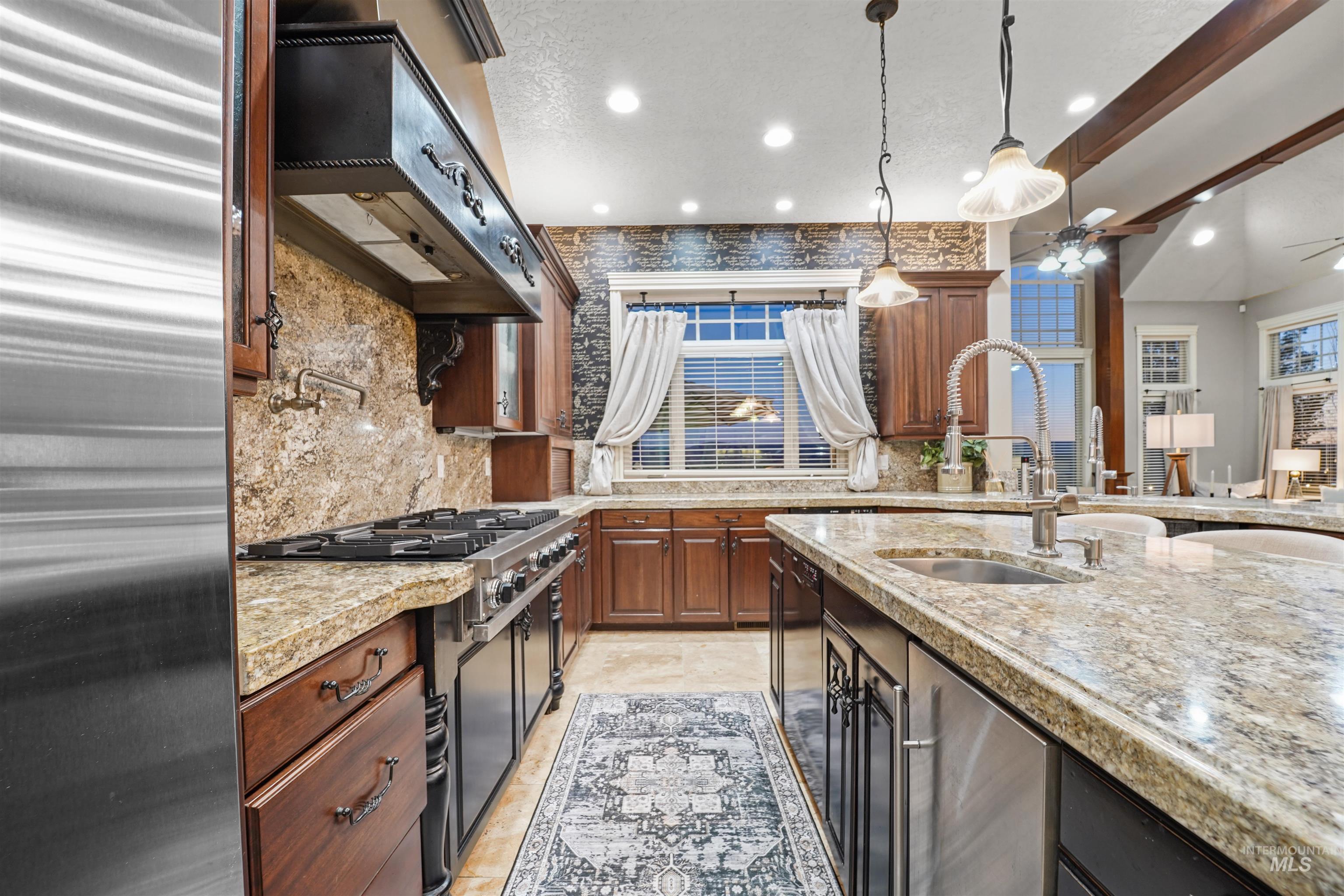 Kitchen with stainless steel appliances, custom exhaust hood, tasteful backsplash, a ceiling fan, and recessed lighting