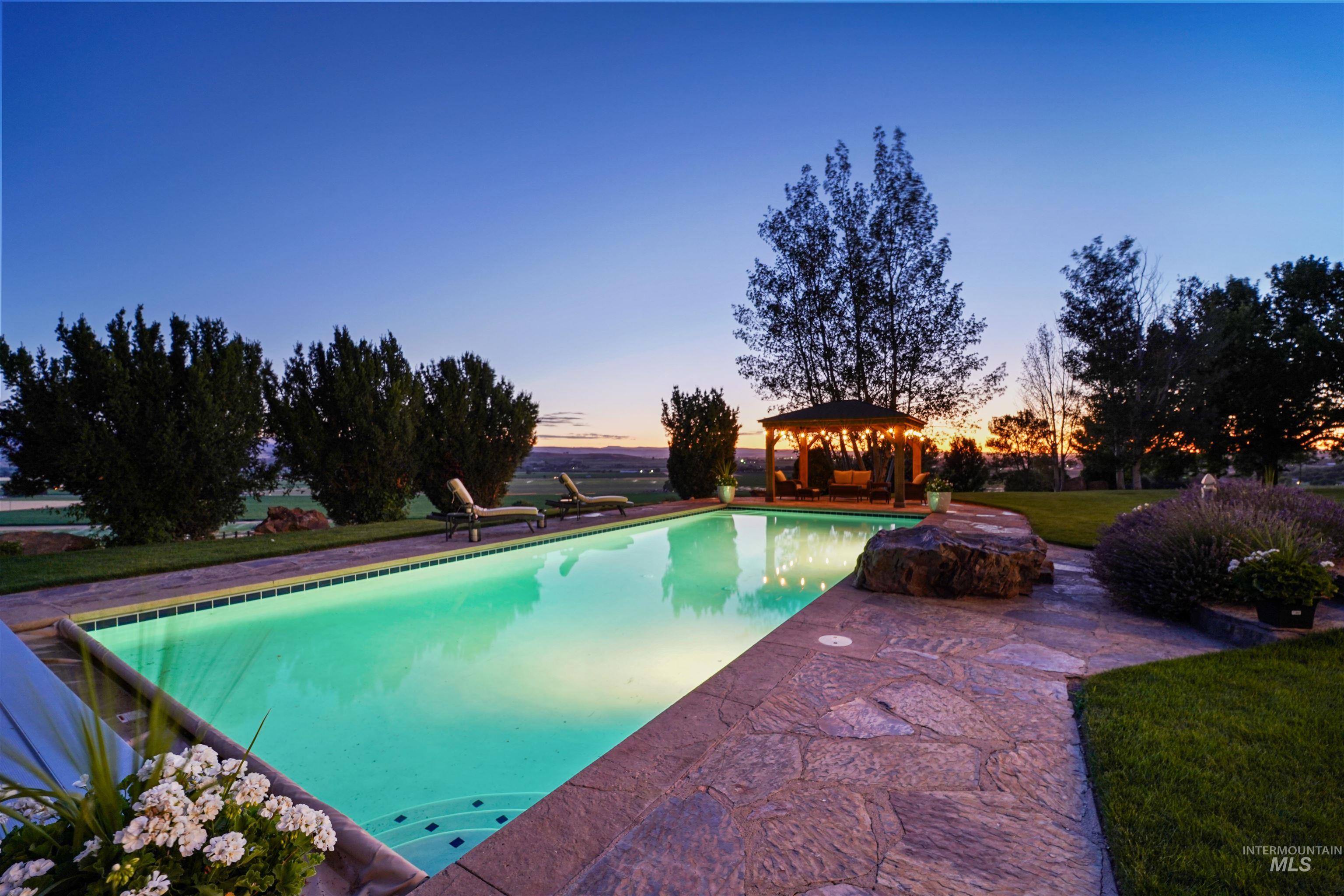 Swimming pool with a gazebo and a patio area