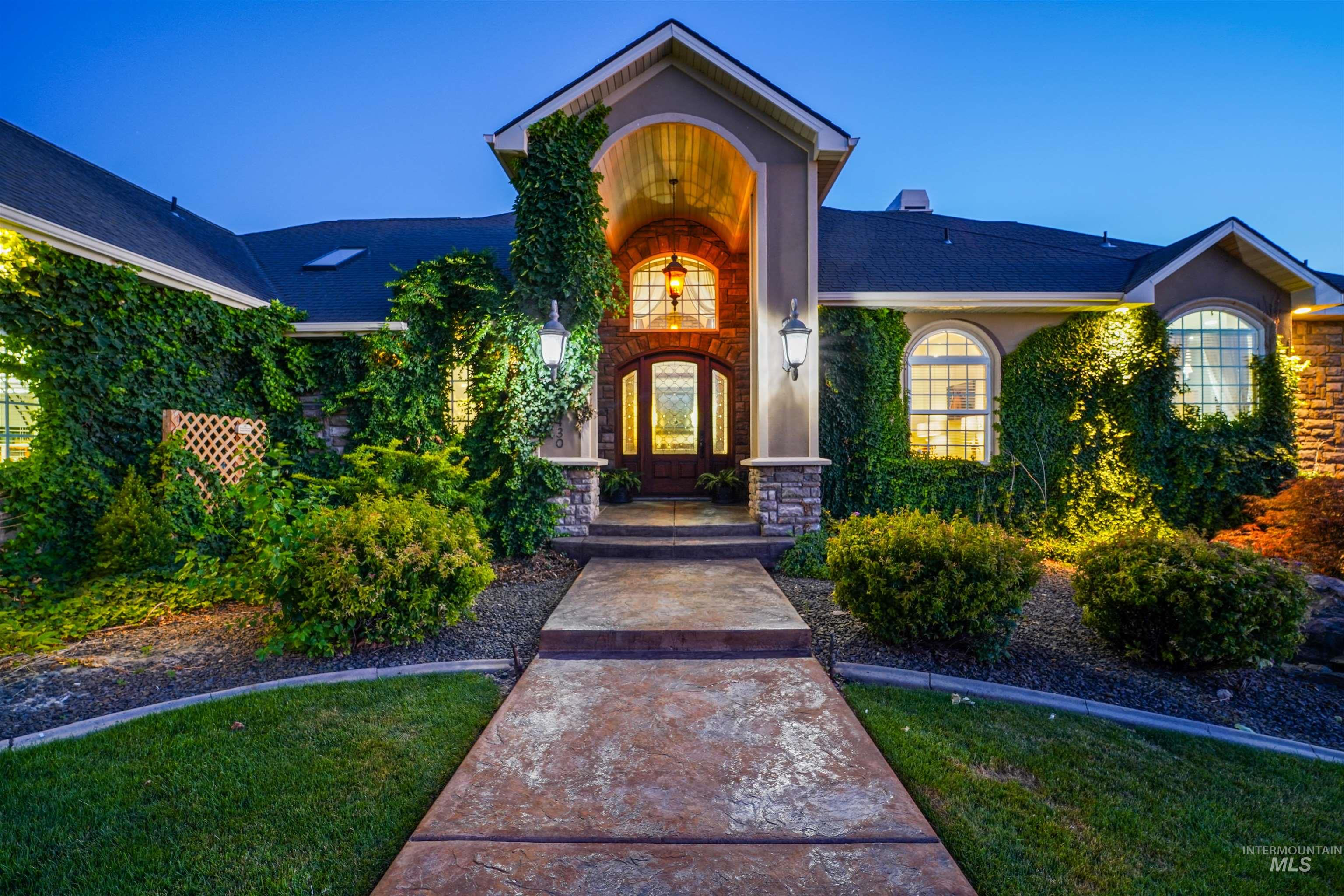 Doorway to property featuring roof with shingles