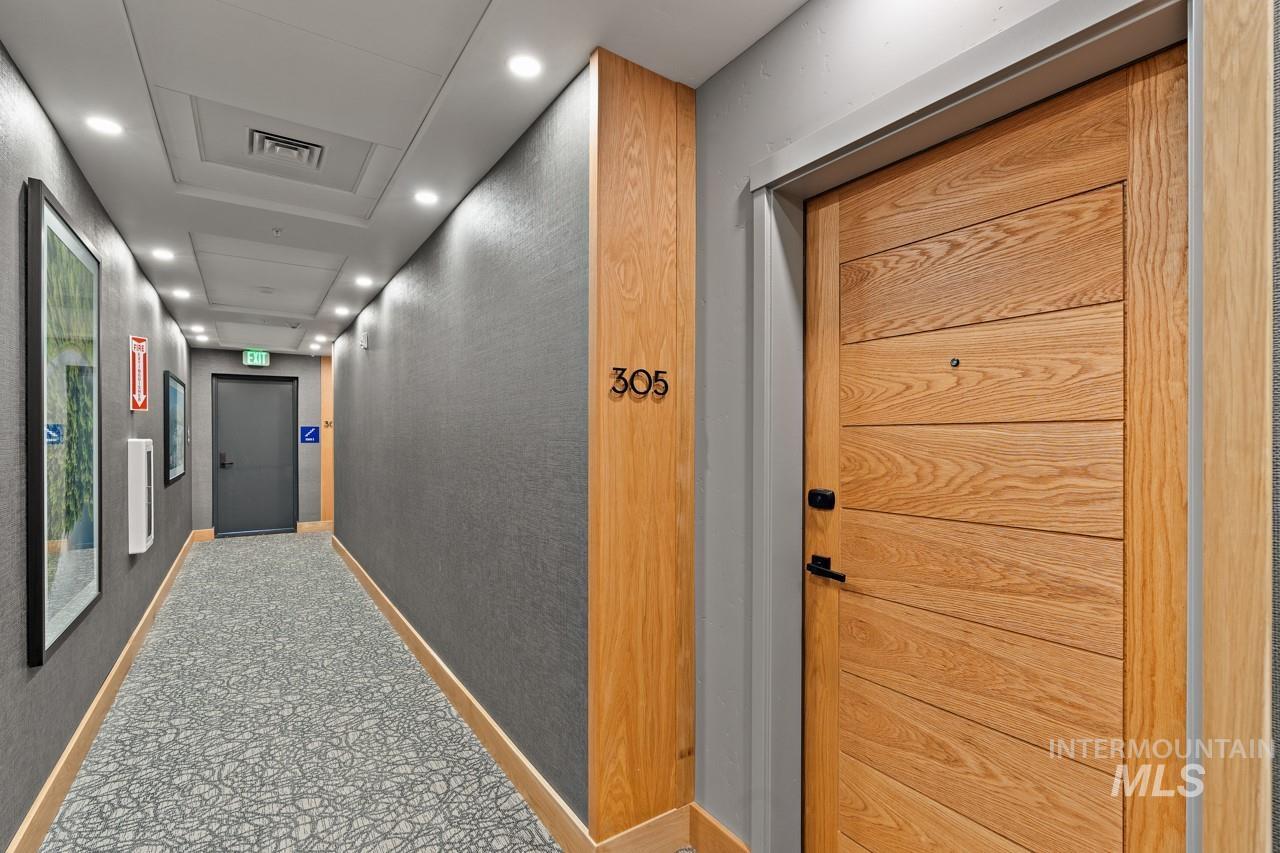 Hallway featuring recessed lighting and tile patterned flooring