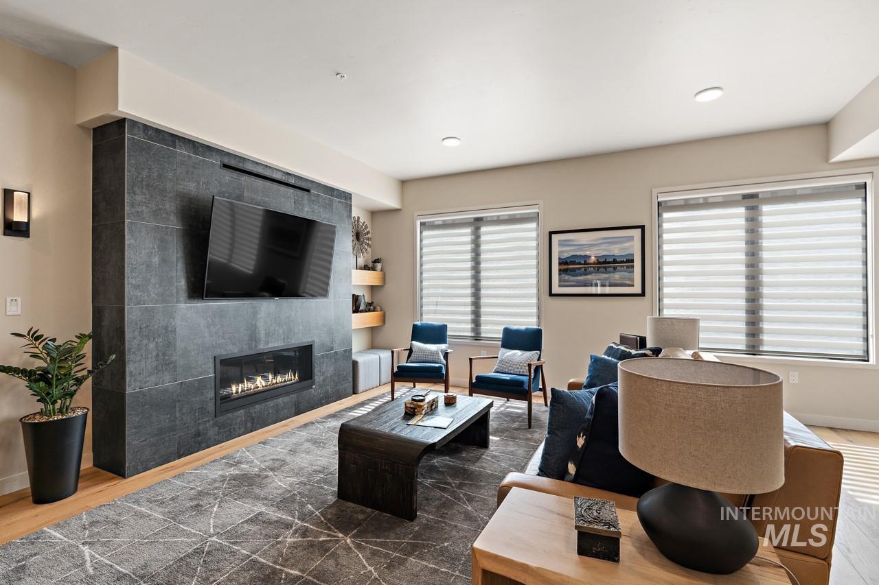 Living area featuring a tiled fireplace and wood finished floors