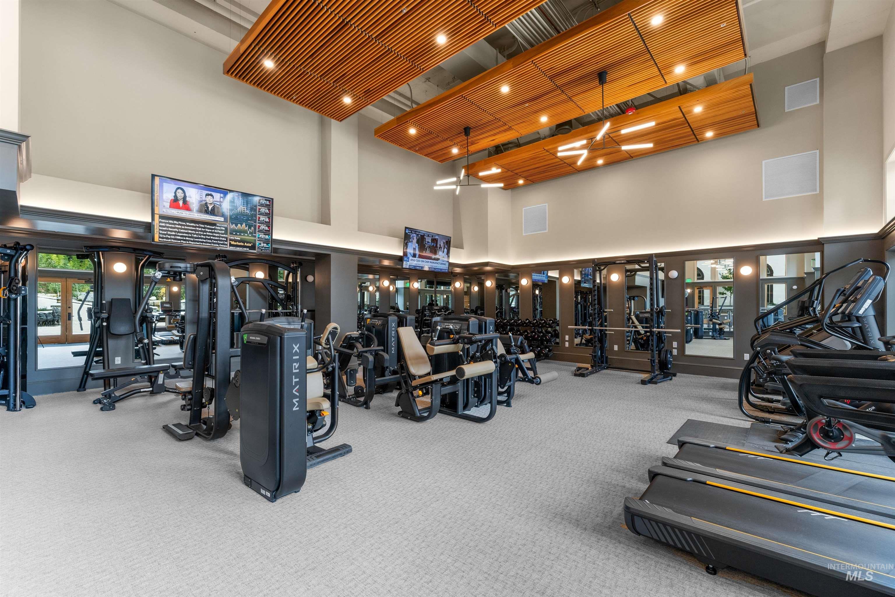 Workout area featuring a towering ceiling and carpet