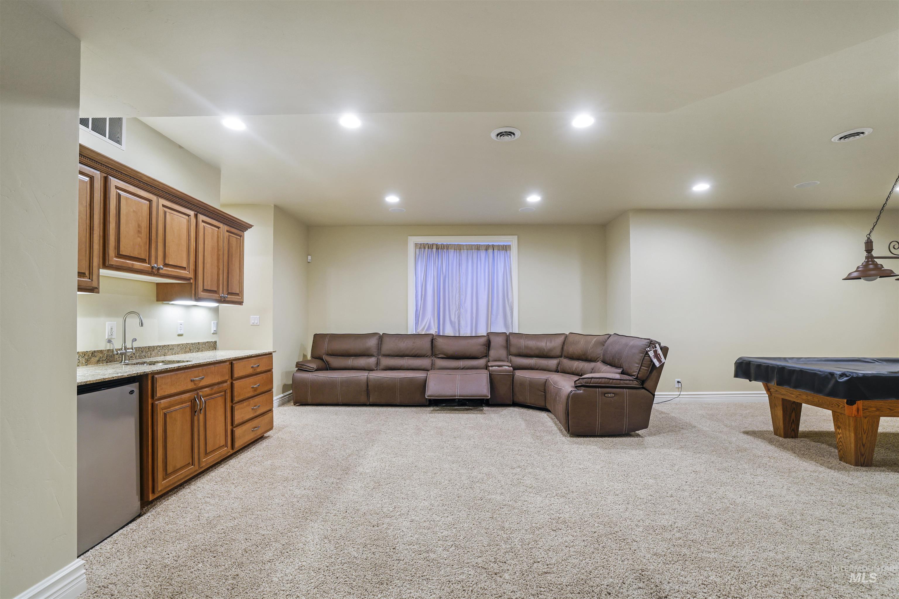 Living area featuring light carpet, recessed lighting, and billiards table