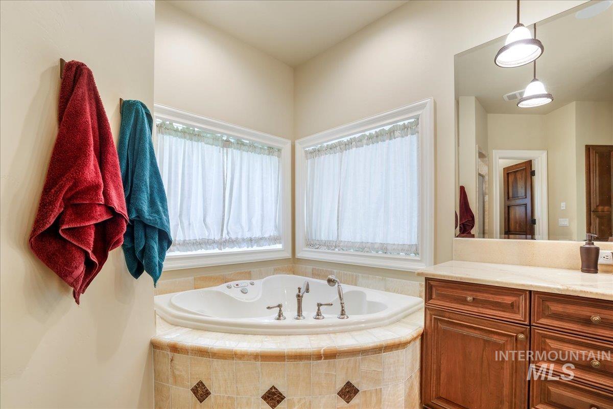 Bathroom featuring vanity and a garden tub
