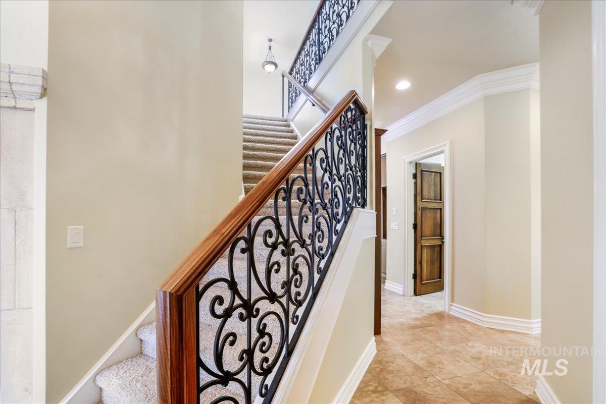 Stairway with ornamental molding and recessed lighting