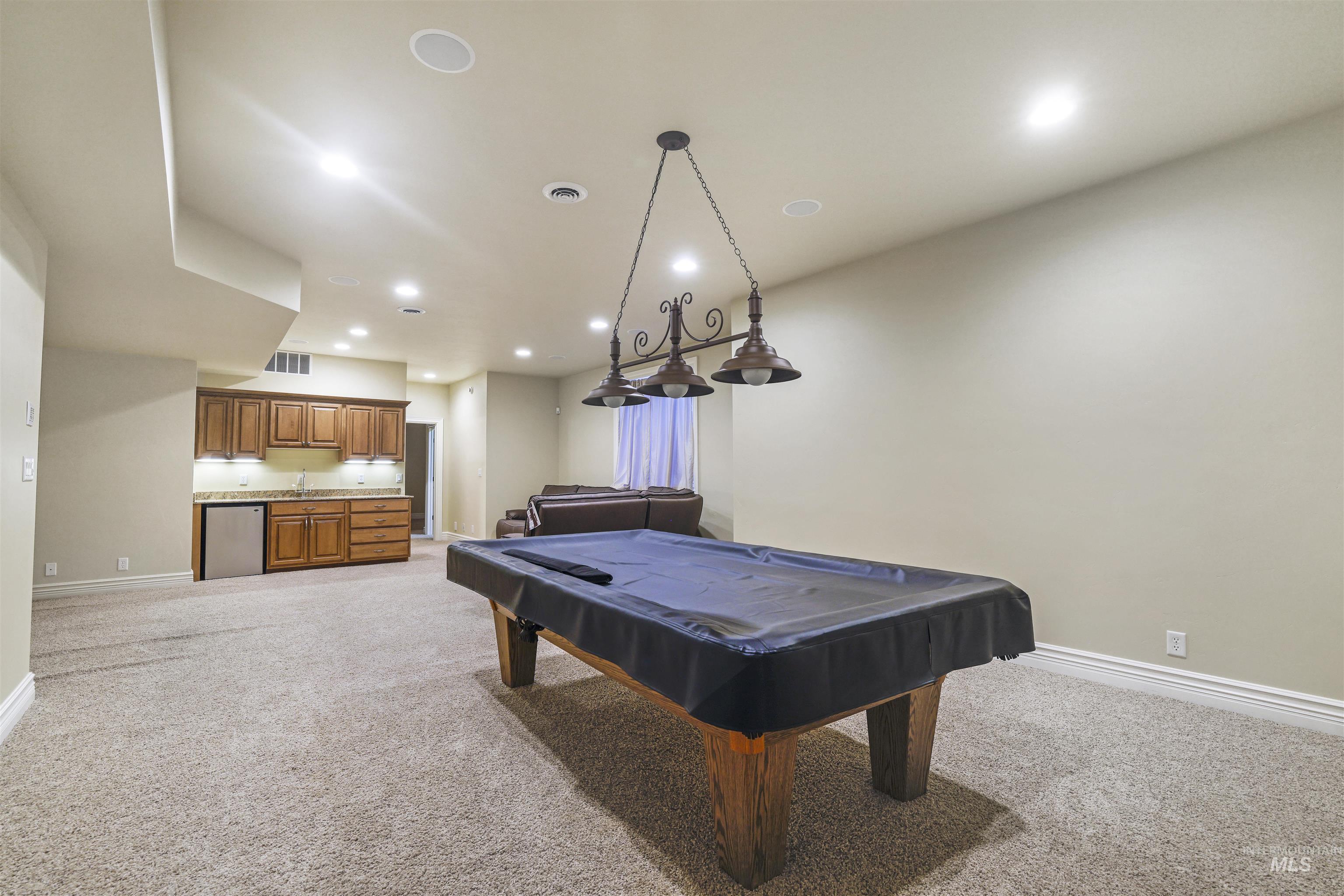 Recreation room with light carpet, recessed lighting, and pool table