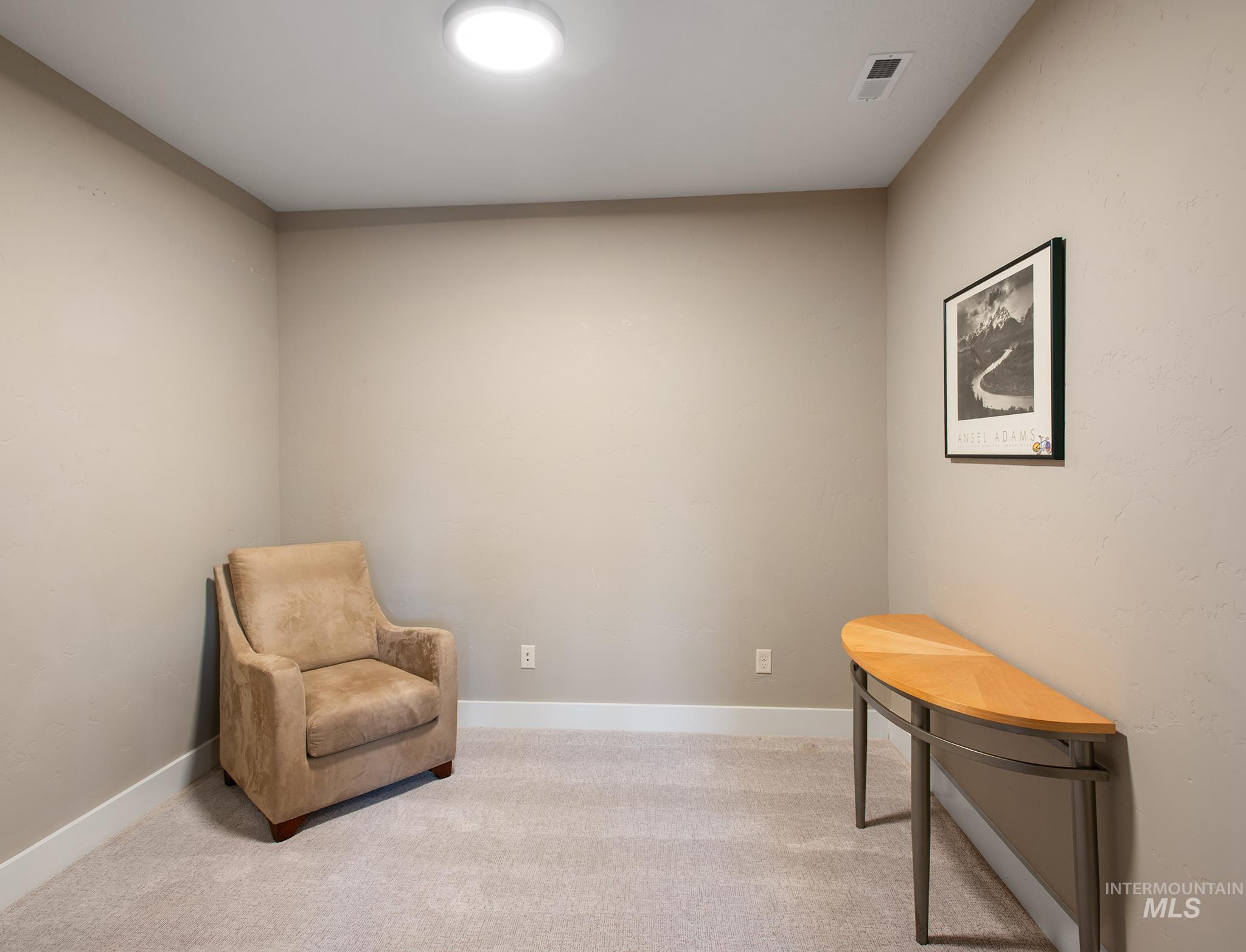 Living area with carpet and baseboards